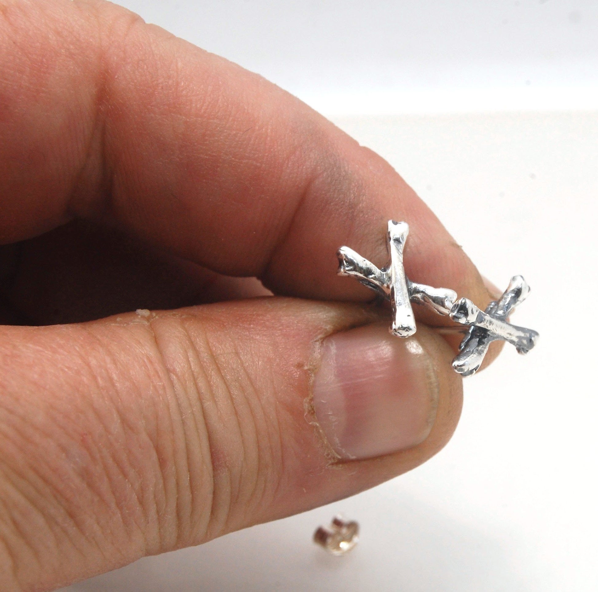 Crossbones Studs These solid sterling silver Crossbones Studs are wax carved by hand and cast using the ancient process of Lost Wax to cast them in sterling silver. I then made a mold, which I can inject with wax and make wax copies of the Crossbones and
