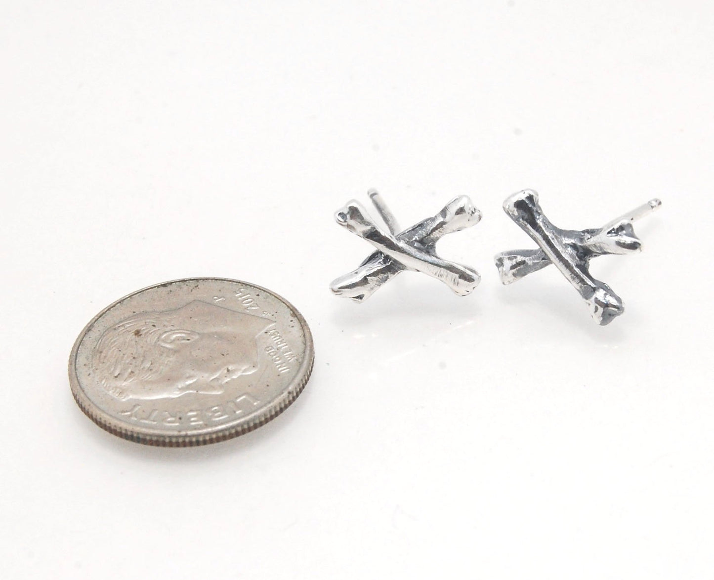 Crossbones Studs These solid sterling silver Crossbones Studs are wax carved by hand and cast using the ancient process of Lost Wax to cast them in sterling silver. I then made a mold, which I can inject with wax and make wax copies of the Crossbones and