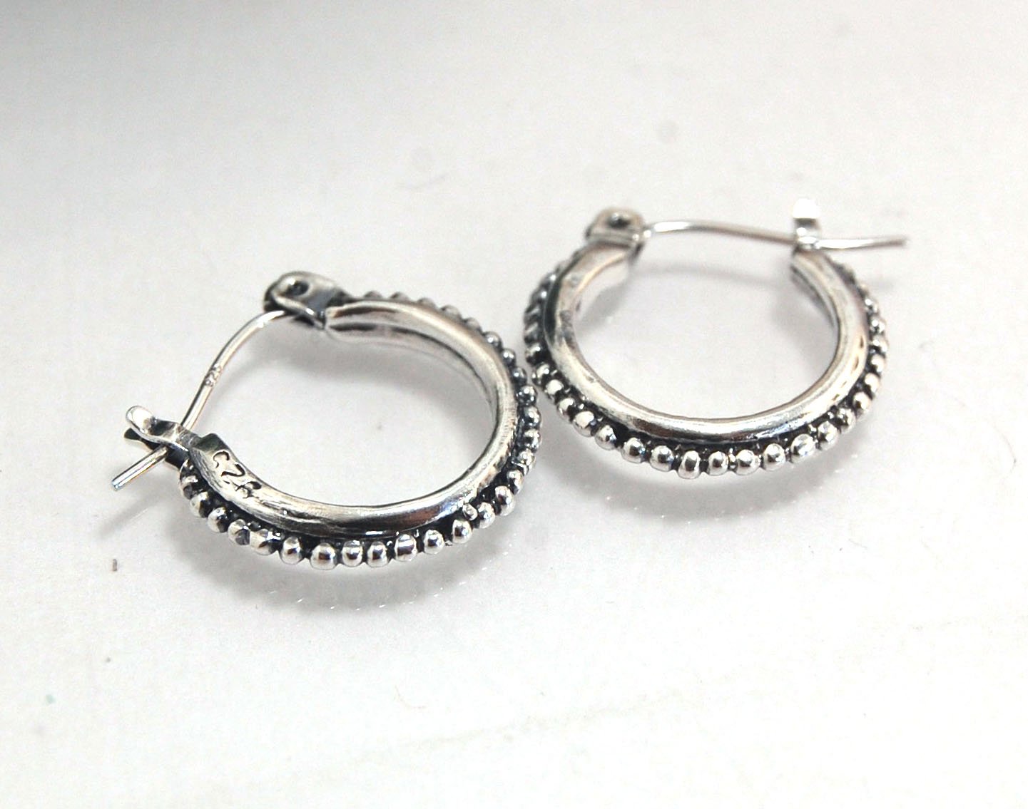 Etruscan hoops in Sterling Silver - Small These sterling silver hoops are cast in my studio (actually on the deck as casting needs good ventilation) from a granulated master for a limited edition series of hoops. I use fine silver for the original granula