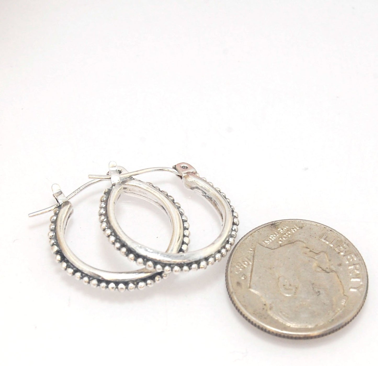 Etruscan hoops in Sterling Silver - Medium These sterling silver hoops are cast in my studio from a granulated master for a limited edition series of cast, granulated hoops. I use fine silver for the original granulation, then make a mold, pull a wax copy