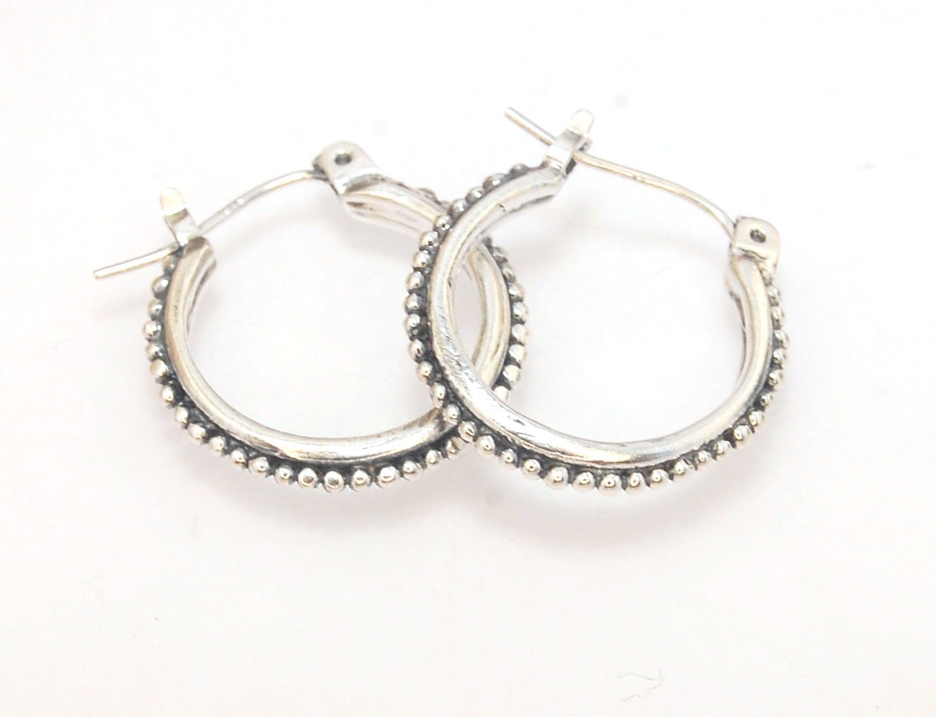 Etruscan hoops in Sterling Silver - Medium These sterling silver hoops are cast in my studio from a granulated master for a limited edition series of cast, granulated hoops. I use fine silver for the original granulation, then make a mold, pull a wax copy