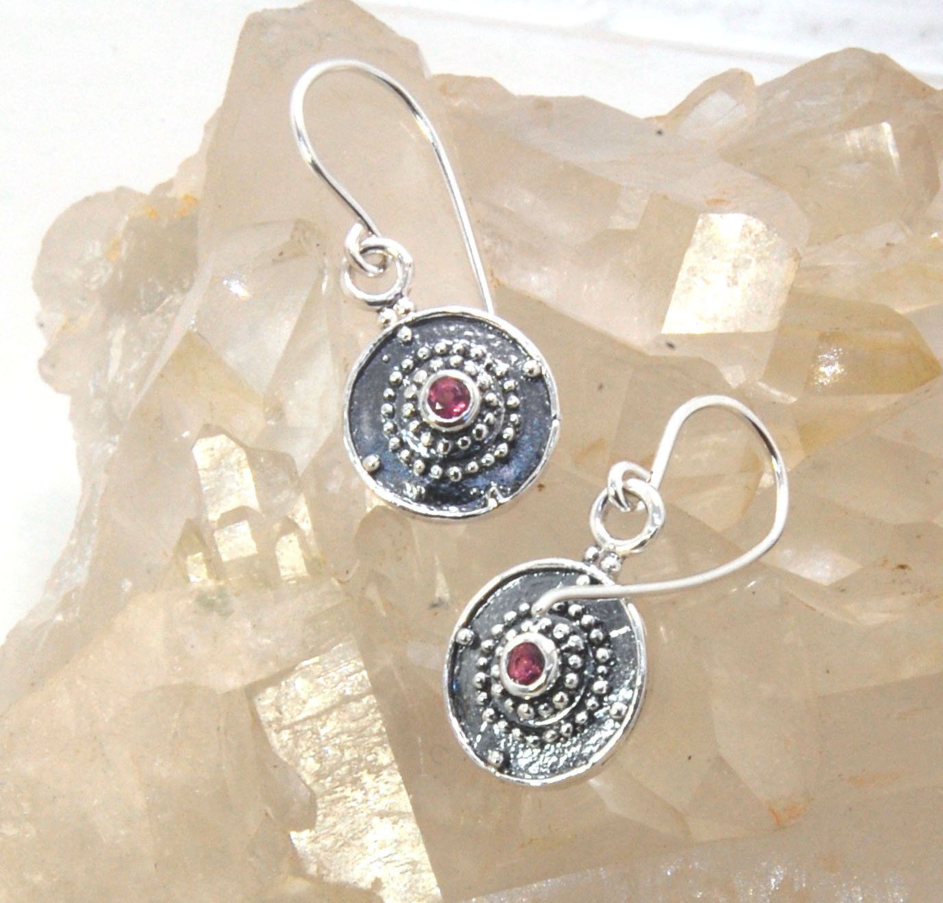 Dangle Shield Earrings in Sterling with Pink Garnet, Red Garnet, Blue Topaz, Peridot, or Amethyst These terrific shield earrings are cast from a granulated original. and is cast using the lost wax process. You can choose which stone to set in your sterlin