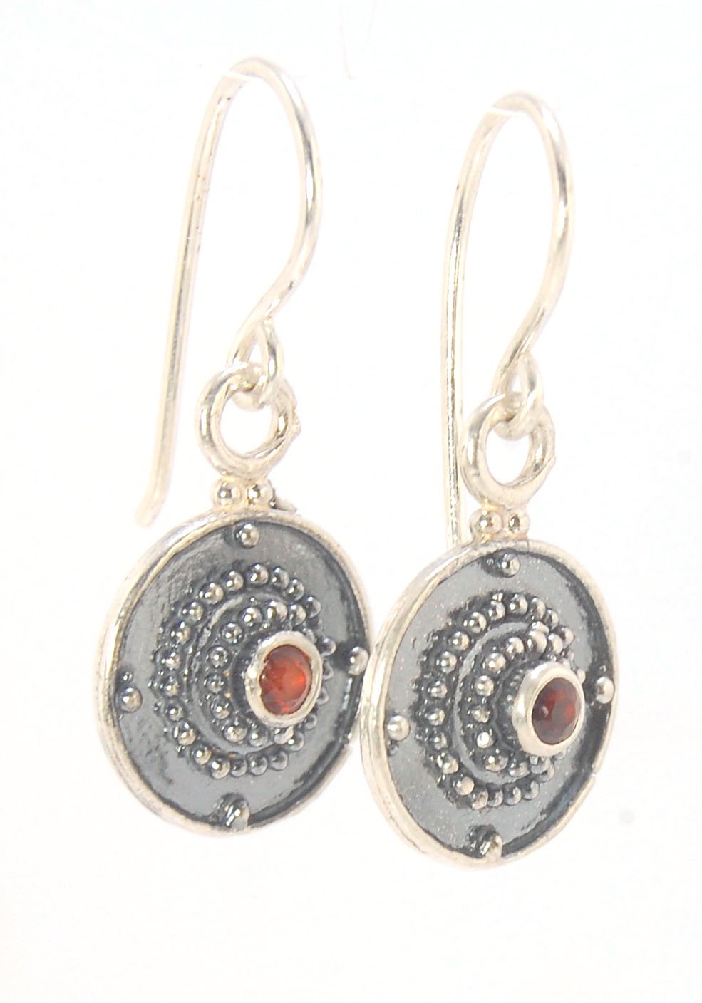 Dangle Shield Earrings in Sterling with Pink Garnet, Red Garnet, Blue Topaz, Peridot, or Amethyst These terrific shield earrings are cast from a granulated original. and is cast using the lost wax process. You can choose which stone to set in your sterlin
