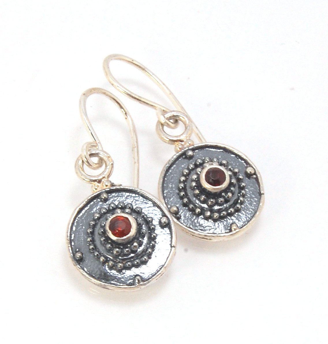 Dangle Shield Earrings in Sterling with Pink Garnet, Red Garnet, Blue Topaz, Peridot, or Amethyst These terrific shield earrings are cast from a granulated original. and is cast using the lost wax process. You can choose which stone to set in your sterlin