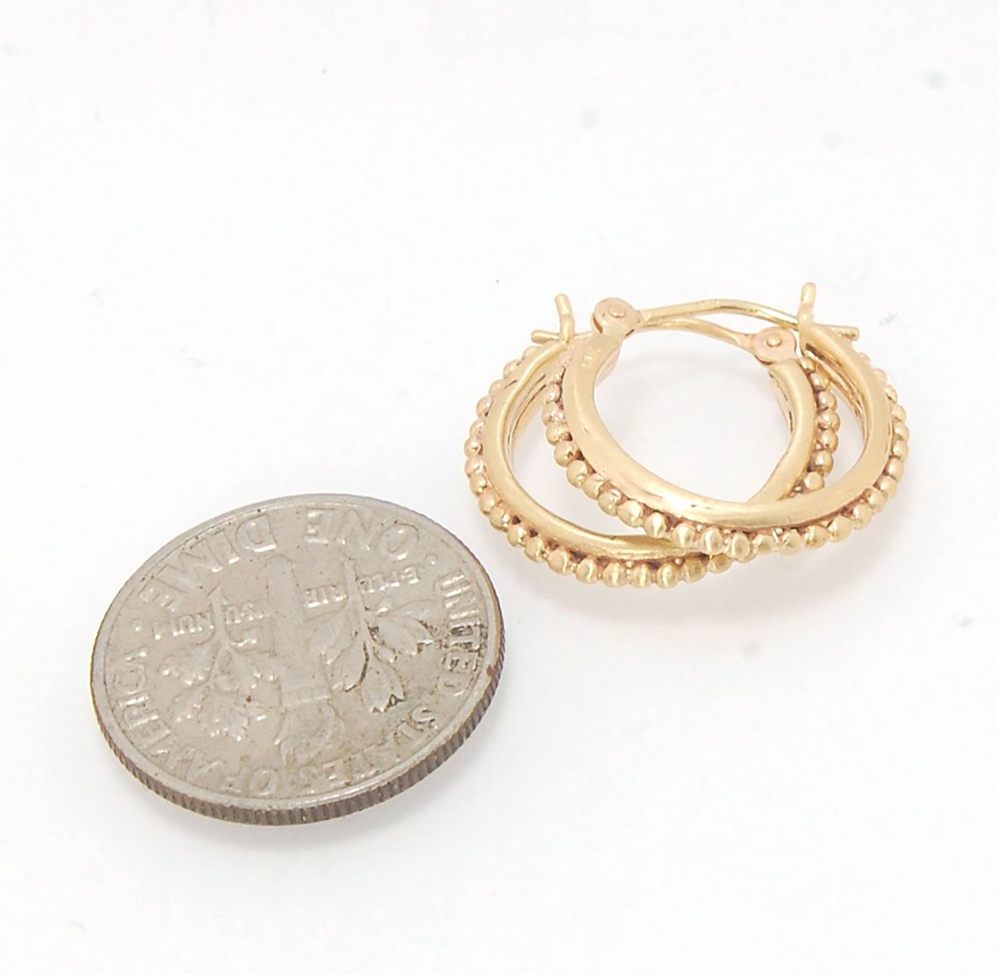 Etruscan hoops in 14k Gold - Medium These 14k yellow gold hoops are cast in my studio from a granulated master for a limited edition series of hoops. I use fine silver for the original granulation, then make a mold, pull a wax copy from the mold, then cas