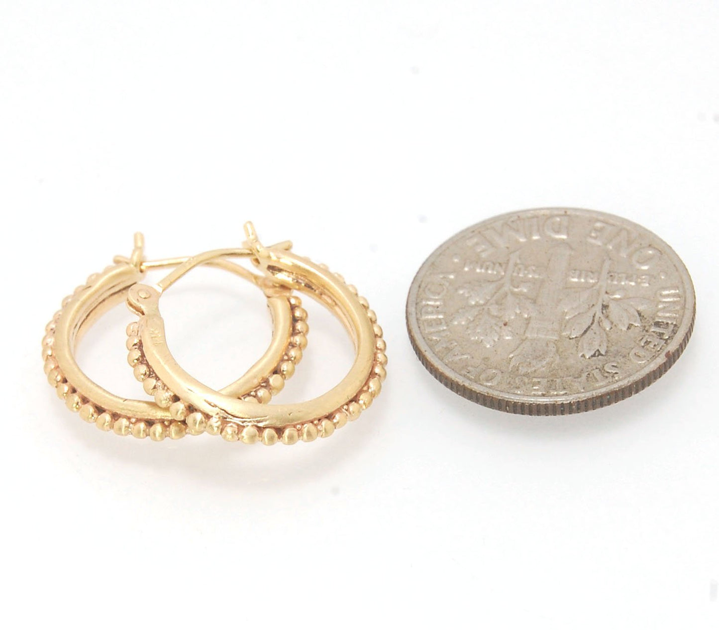 Etruscan hoops in 14k Gold - Medium These 14k yellow gold hoops are cast in my studio from a granulated master for a limited edition series of hoops. I use fine silver for the original granulation, then make a mold, pull a wax copy from the mold, then cas