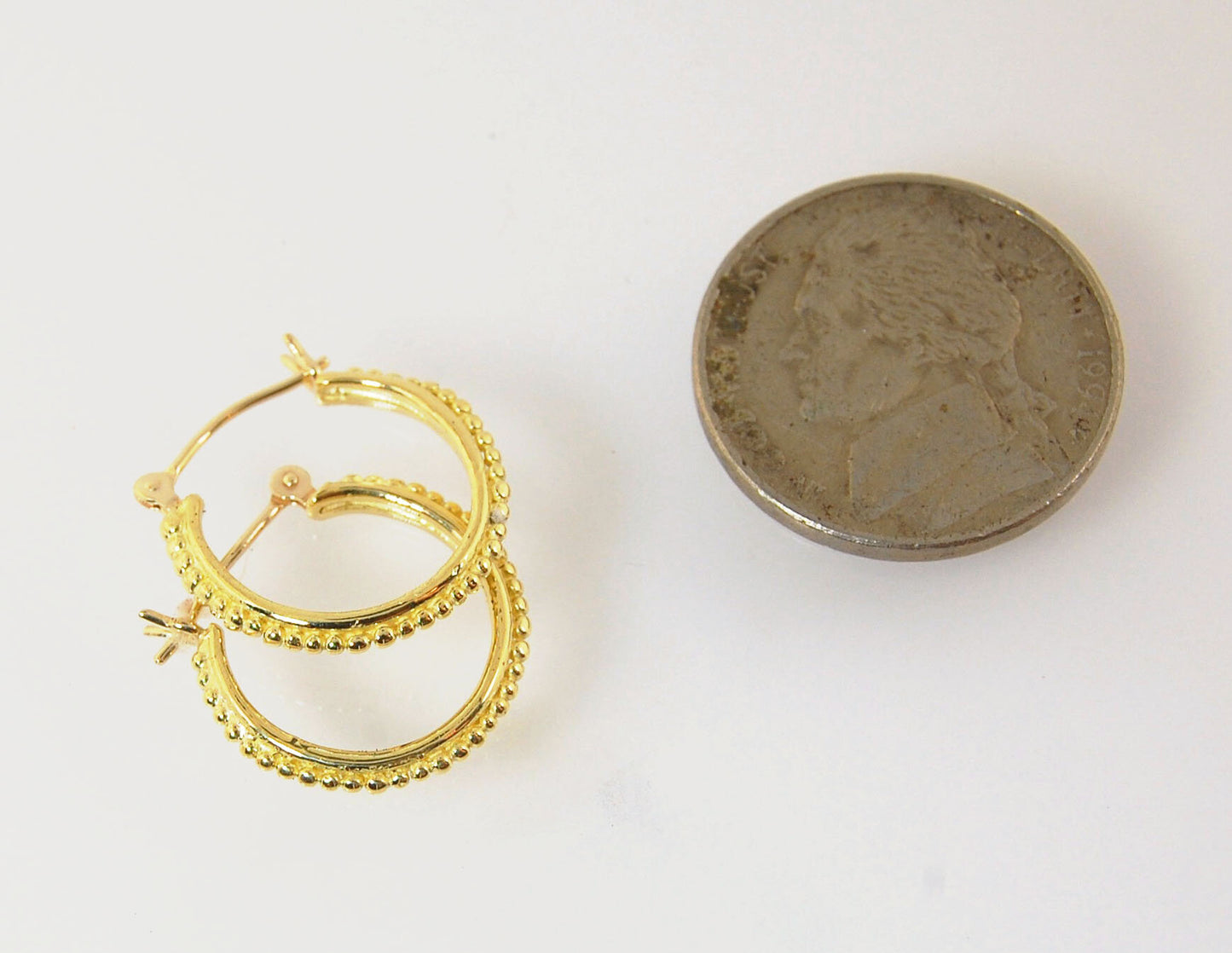 Etruscan hoops in 14k Gold - Medium These 14k yellow gold hoops are cast in my studio from a granulated master for a limited edition series of hoops. I use fine silver for the original granulation, then make a mold, pull a wax copy from the mold, then cas