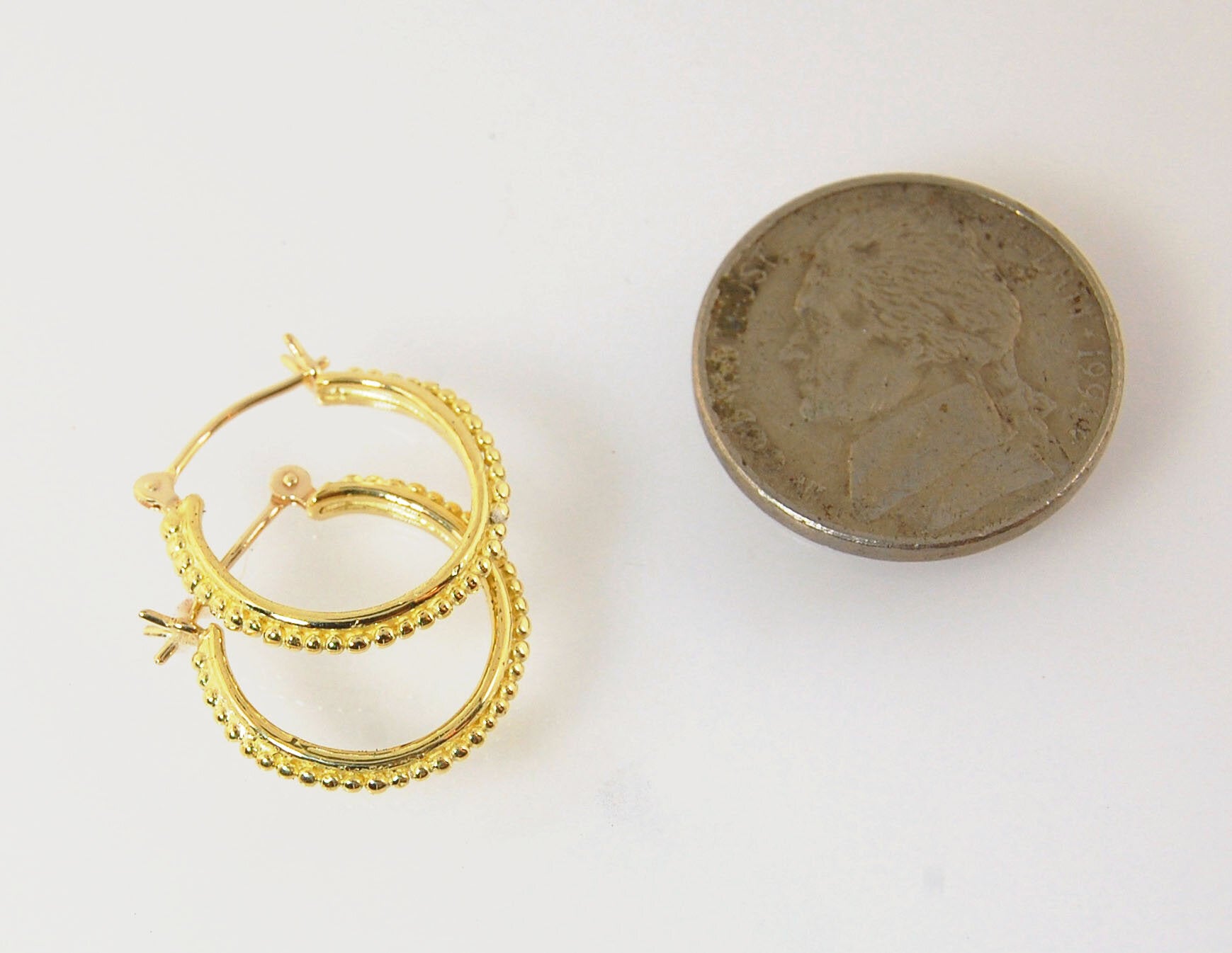 Etruscan hoops in 14k Gold - Small These 14k yellow gold hoops are cast in my studio (actually on the deck as casting needs good ventilation) from a granulated master for a limited edition series of hoops. I use fine silver for the original granulation, t