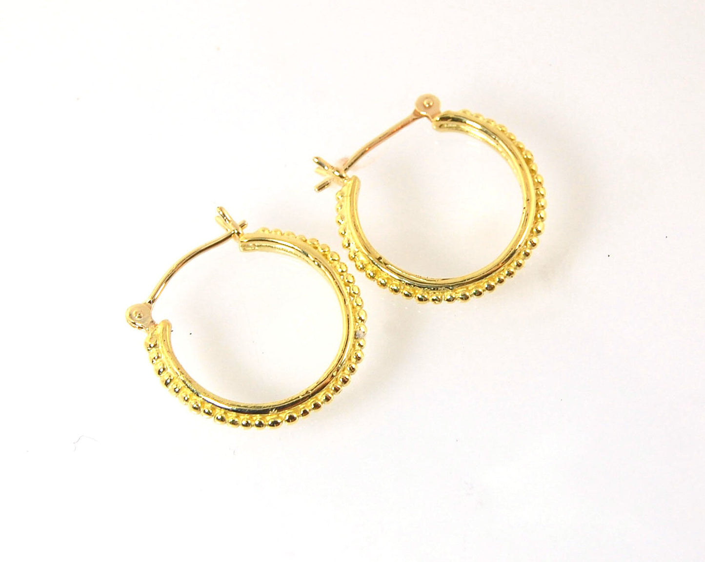 Etruscan hoops in 14k Gold - Medium These 14k yellow gold hoops are cast in my studio from a granulated master for a limited edition series of hoops. I use fine silver for the original granulation, then make a mold, pull a wax copy from the mold, then cas