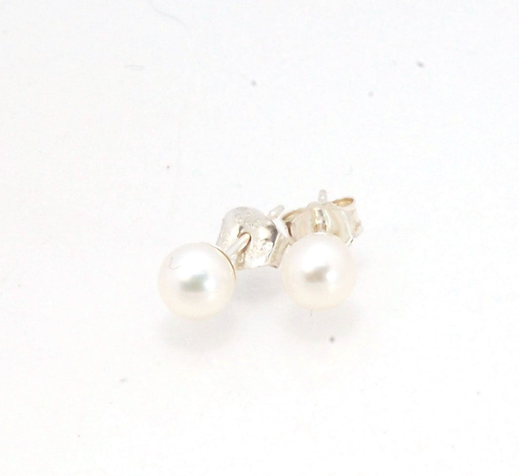 Freshwater White pearls studs in Sterling silver - 6mm These luminous white freshwater pearls are 6mm and set in sterling silver pearl cups and posts with sterling silver ear nuts.6mmSterling Silver and freshwater pearl