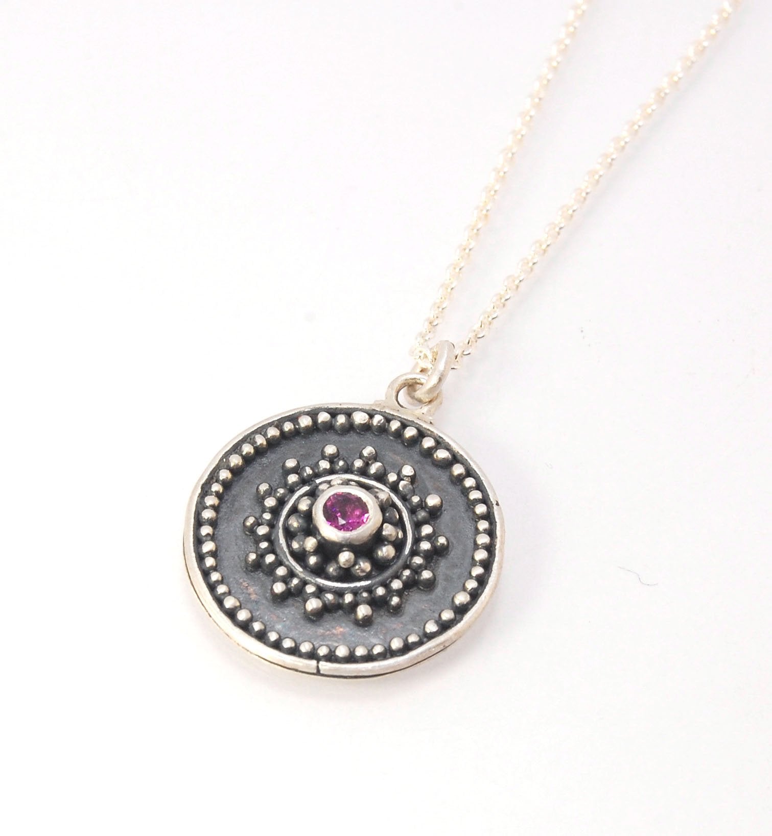 Pink Tourmaline Granulated Disk Pendant Faceted Pink Tourmaline bezel-set in Fine Silver Granulation.Granulation is a controlled fusing process that has been utilized for thousands of years. I melt 999.99% Fine Silver to create granules and wire. The gran