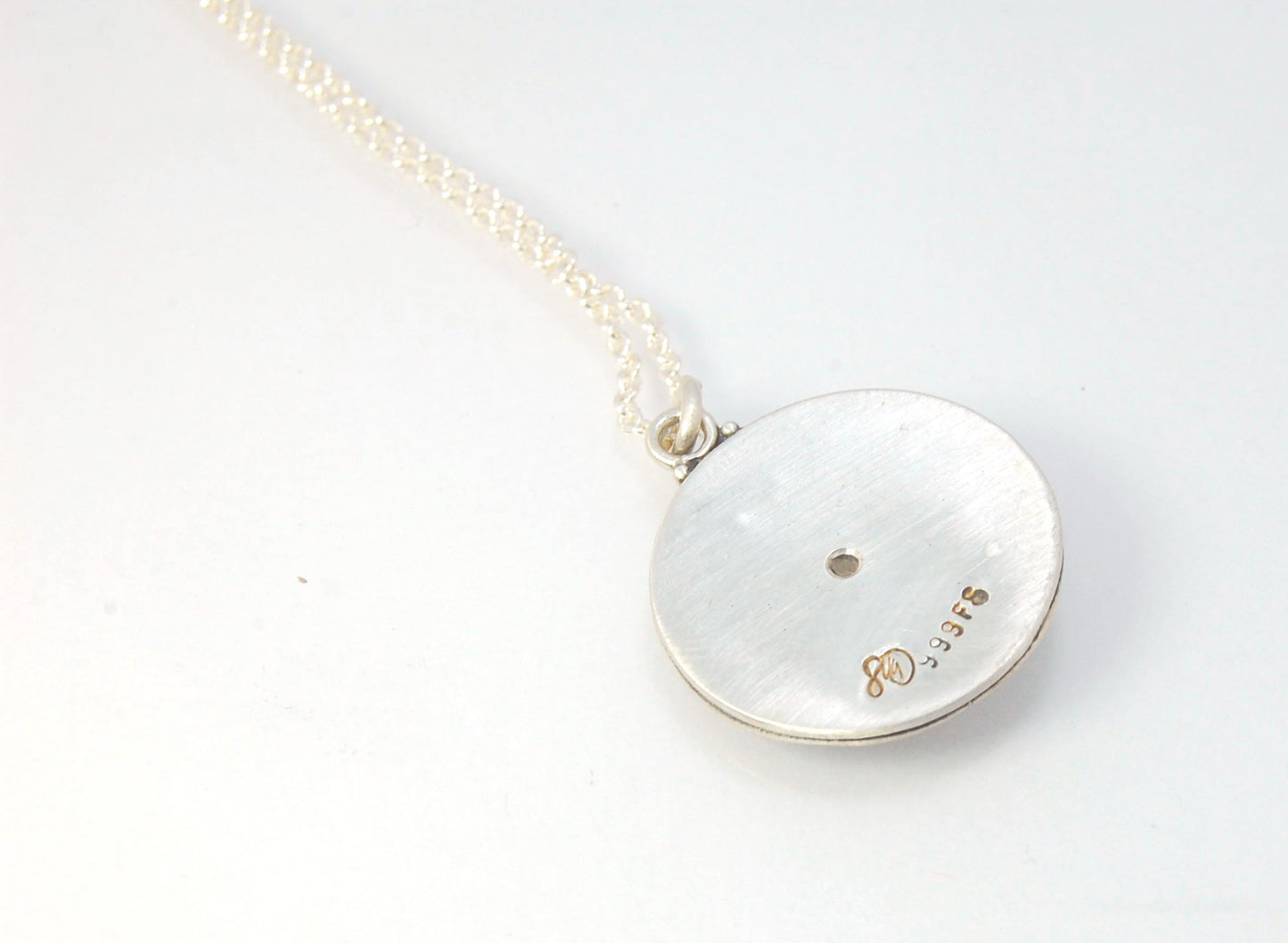 Pink Tourmaline Granulated Disk Pendant Faceted Pink Tourmaline bezel-set in Fine Silver Granulation.Granulation is a controlled fusing process that has been utilized for thousands of years. I melt 999.99% Fine Silver to create granules and wire. The gran