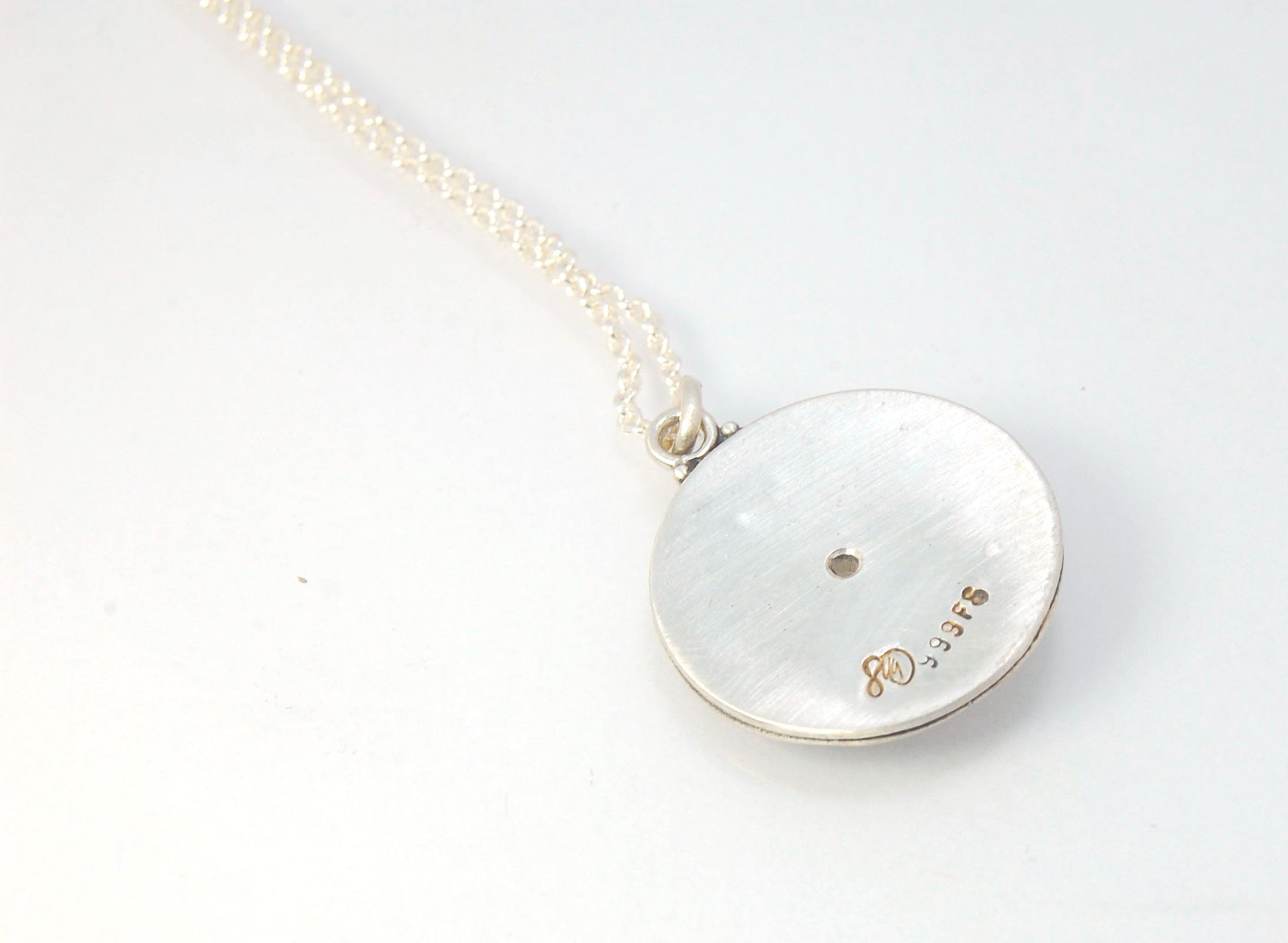 Pink Tourmaline Granulated Disk Pendant Faceted Pink Tourmaline bezel-set in Fine Silver Granulation.Granulation is a controlled fusing process that has been utilized for thousands of years. I melt 999.99% Fine Silver to create granules and wire. The gran