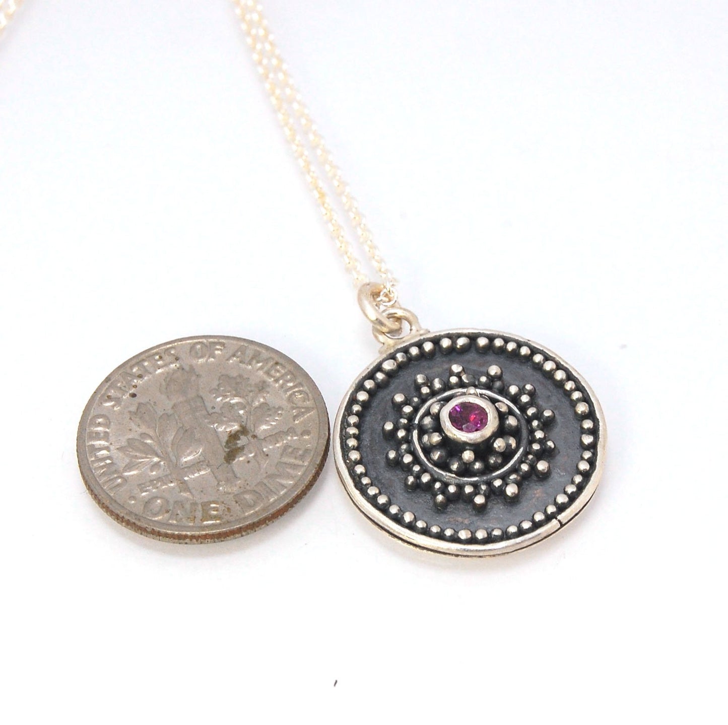 Pink Tourmaline Granulated Disk Pendant Faceted Pink Tourmaline bezel-set in Fine Silver Granulation.Granulation is a controlled fusing process that has been utilized for thousands of years. I melt 999.99% Fine Silver to create granules and wire. The gran
