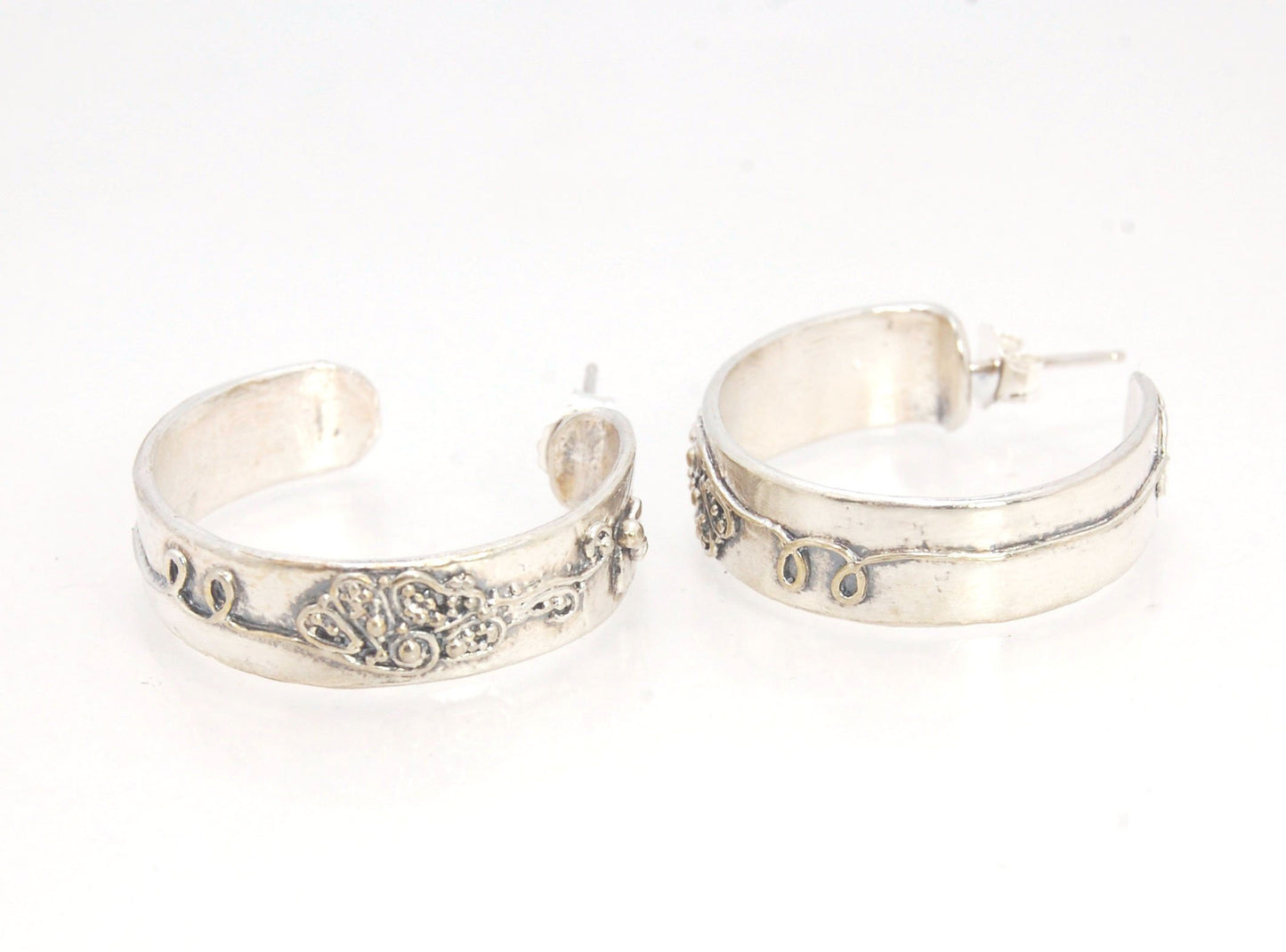 Pollinator Pattern Hoop Posts in Sterling These hoop posts are made from my Pollinator bands and have sterling silver posts and ear nuts. My Pollinator Band has a Bee and flower in tiny granulation. This band is a cast from a mold taken of a ring I granul