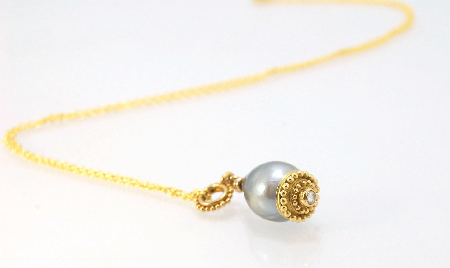 Baroque Grey Pearl with 18k gold Granulation and a Rosecut Diamond Ok this one is a stunner. 18k gold Granulated Dome with a 2.5 mm Rosecut Diamond and Granulated Bail pictured on an 18” peacock black oxidized Sterling Silver chain. Granulation is an anci