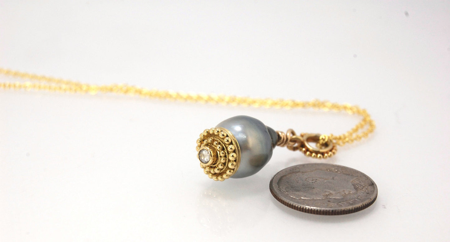 Baroque Grey Pearl with 18k gold Granulation and a Rosecut Diamond Ok this one is a stunner. 18k gold Granulated Dome with a 2.5 mm Rosecut Diamond and Granulated Bail pictured on an 18” peacock black oxidized Sterling Silver chain. Granulation is an anci