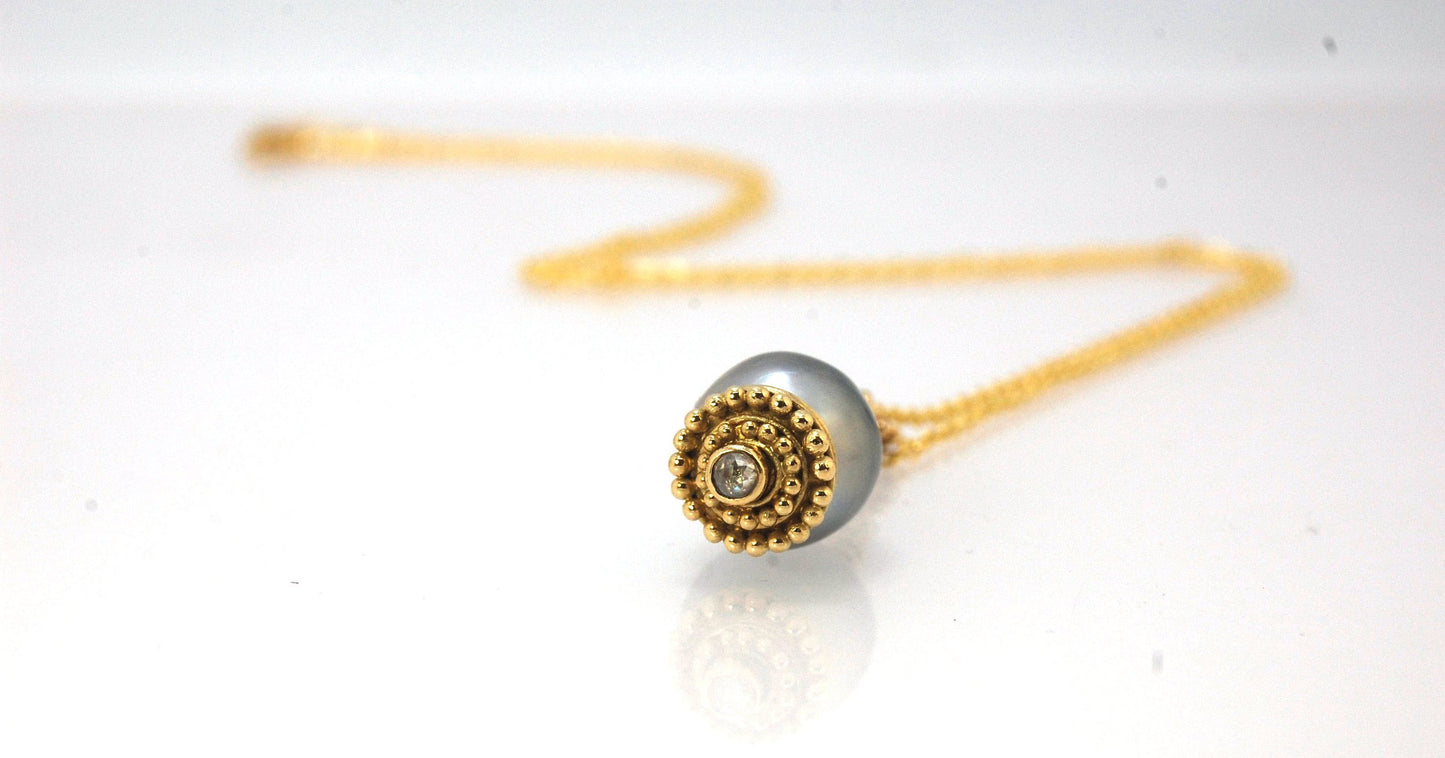 Baroque Grey Pearl with 18k gold Granulation and a Rosecut Diamond Ok this one is a stunner. 18k gold Granulated Dome with a 2.5 mm Rosecut Diamond and Granulated Bail pictured on an 18” peacock black oxidized Sterling Silver chain. Granulation is an anci