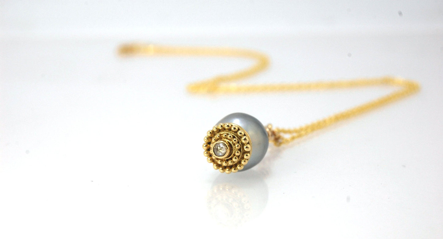 Baroque Grey Pearl with 18k gold Granulation and a Rosecut Diamond Ok this one is a stunner. 18k gold Granulated Dome with a 2.5 mm Rosecut Diamond and Granulated Bail pictured on an 18” peacock black oxidized Sterling Silver chain. Granulation is an anci