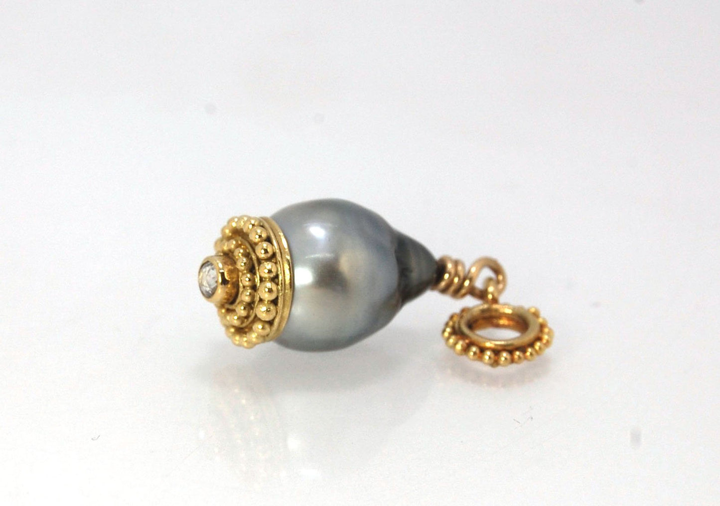 Baroque Grey Pearl with 18k gold Granulation and a Rosecut Diamond Ok this one is a stunner. 18k gold Granulated Dome with a 2.5 mm Rosecut Diamond and Granulated Bail pictured on an 18” peacock black oxidized Sterling Silver chain. Granulation is an anci