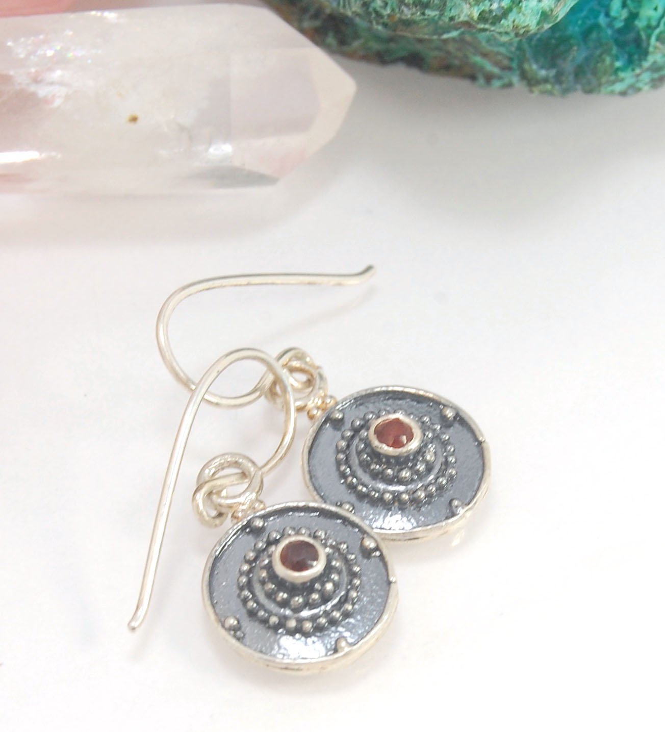 Dangle Shield Earrings in Sterling with Pink Garnet, Red Garnet, Blue Topaz, Peridot, or Amethyst These terrific shield earrings are cast from a granulated original. and is cast using the lost wax process. You can choose which stone to set in your sterlin