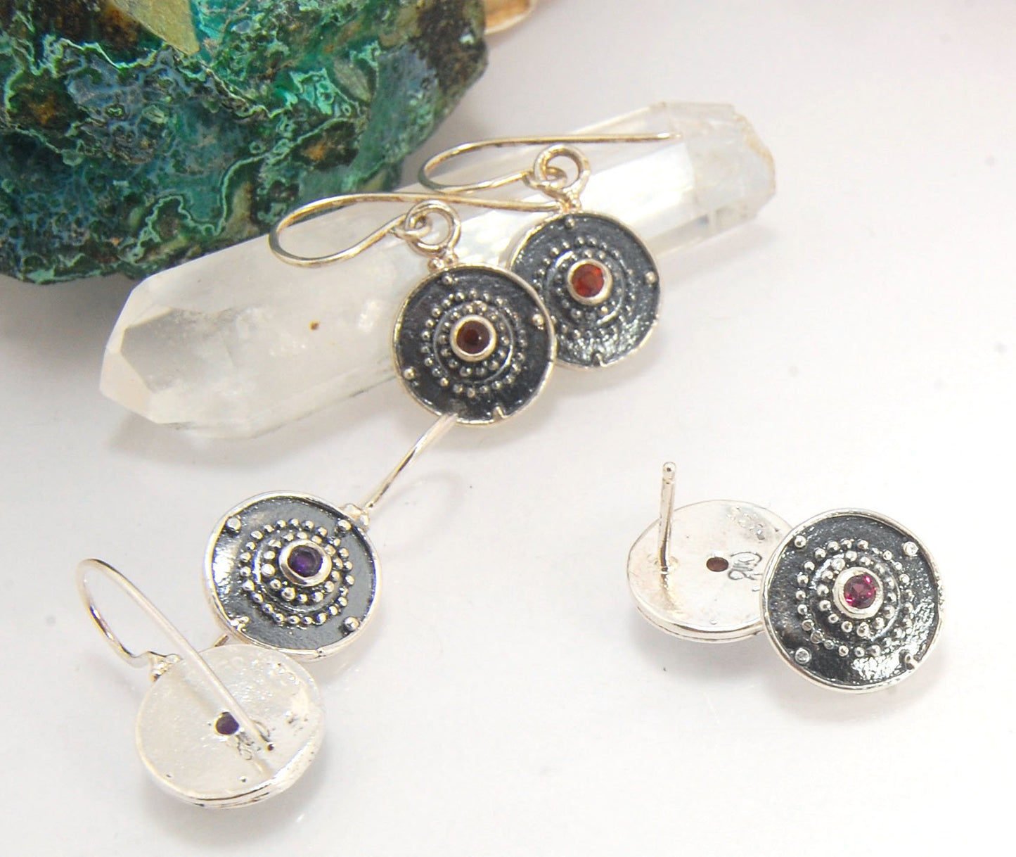 Dangle Shield Earrings in Sterling with Pink Garnet, Red Garnet, Blue Topaz, Peridot, or Amethyst These terrific shield earrings are cast from a granulated original. and is cast using the lost wax process. You can choose which stone to set in your sterlin