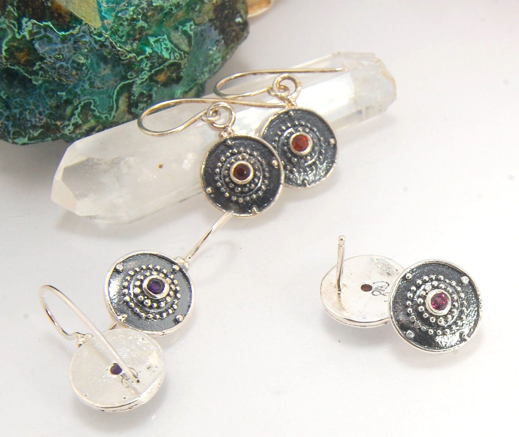 Dangle Shield Earrings in Sterling with Pink Garnet, Red Garnet, Blue Topaz, Peridot, or Amethyst These terrific shield earrings are cast from a granulated original. and is cast using the lost wax process. You can choose which stone to set in your sterlin