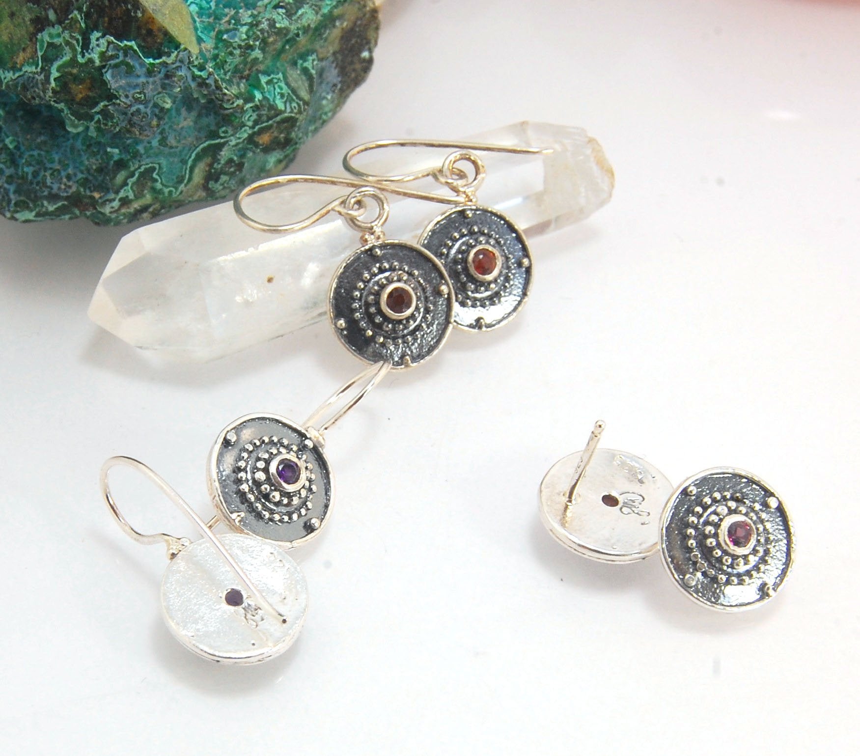 Dangle Shield Earrings in Sterling with Pink Garnet, Red Garnet, Blue Topaz, Peridot, or Amethyst These terrific shield earrings are cast from a granulated original. and is cast using the lost wax process. You can choose which stone to set in your sterlin