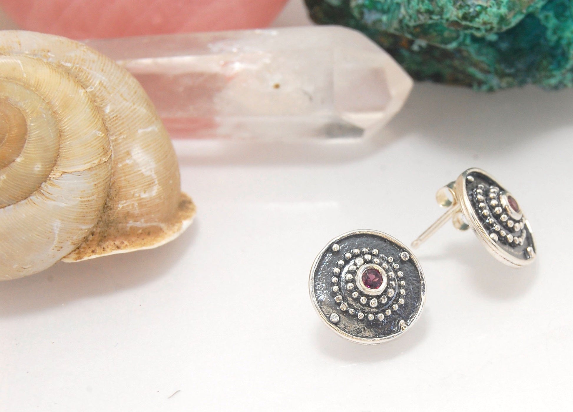 Post Shield Earrings in Sterling with Pink Garnet, Red Garnet, Blue Topaz, Peridot or Amethyst These terrific shield earrings are cast from a granulated original. and is cast using the lost wax process. You can choose which stone to set in your sterling s