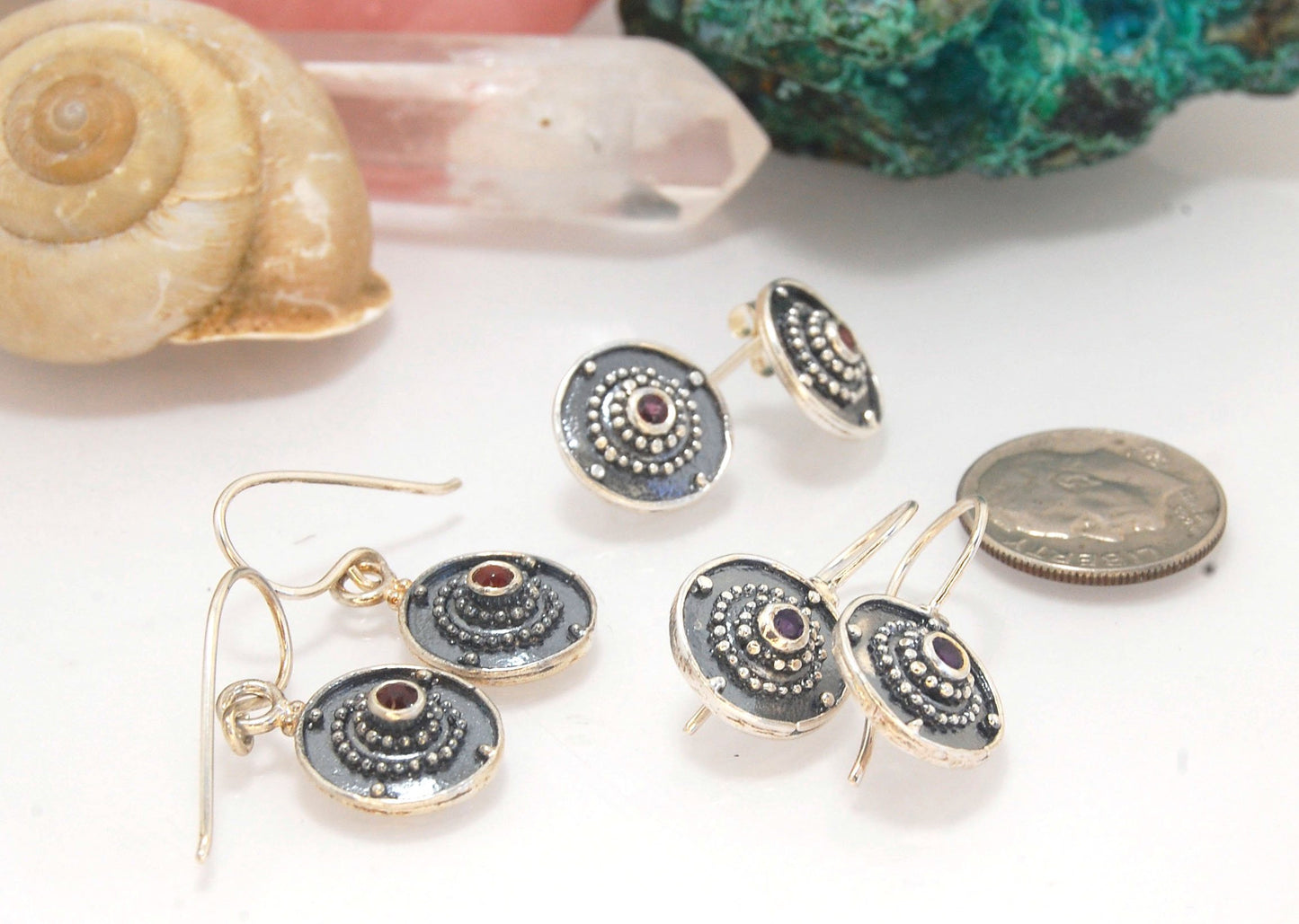 Dangle Shield Earrings in Sterling with Pink Garnet, Red Garnet, Blue Topaz, Peridot, or Amethyst These terrific shield earrings are cast from a granulated original. and is cast using the lost wax process. You can choose which stone to set in your sterlin