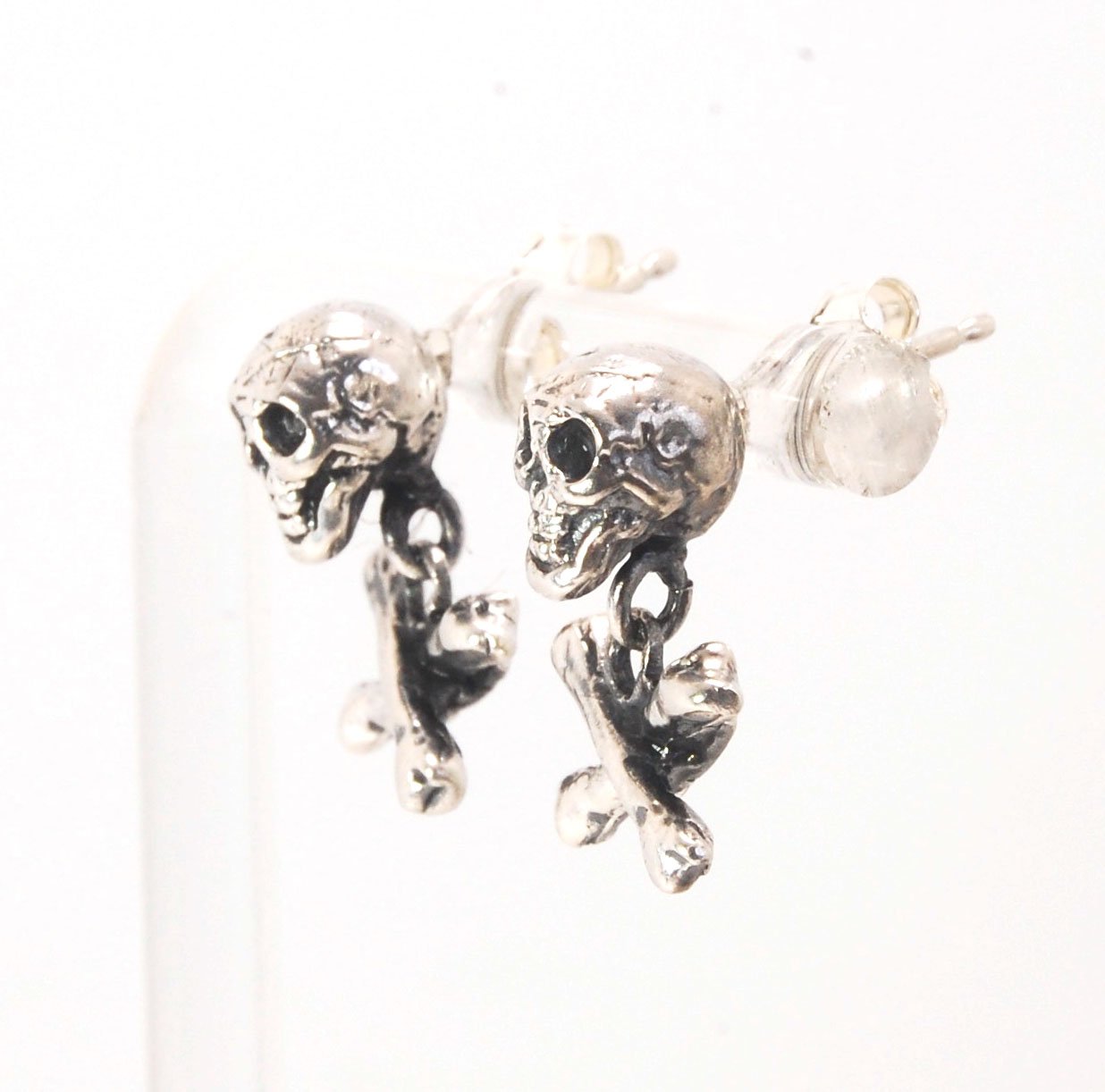Skull & Bones Dangle Post Earrings These solid sterling silver Skull & Bones dangle earrings are wax carved by hand and cast using the ancient process of Lost Wax to cast them in sterling silver. I then made a mold, which I can inject with wax and make wa