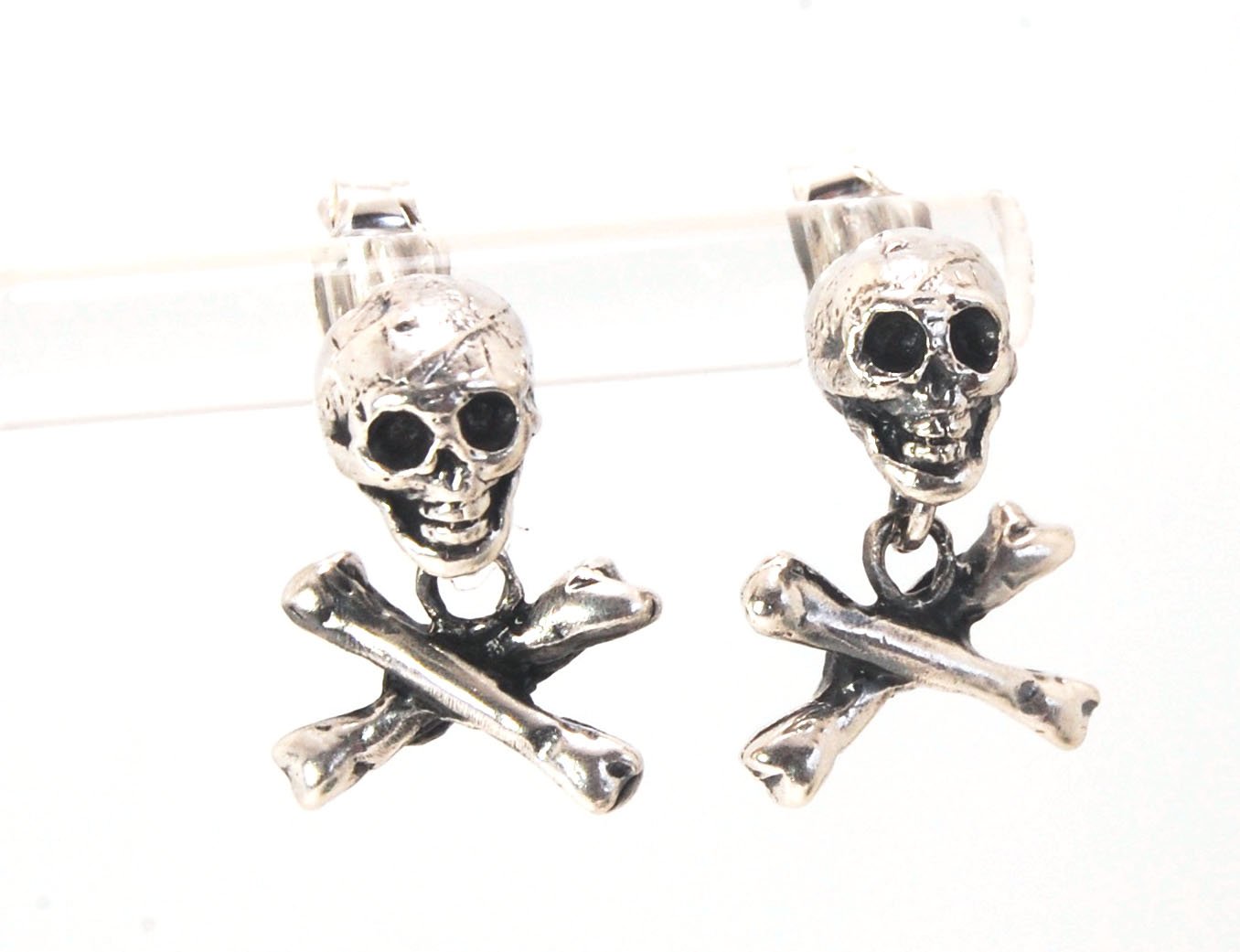 Skull & Bones Dangle Post Earrings These solid sterling silver Skull & Bones dangle earrings are wax carved by hand and cast using the ancient process of Lost Wax to cast them in sterling silver. I then made a mold, which I can inject with wax and make wa