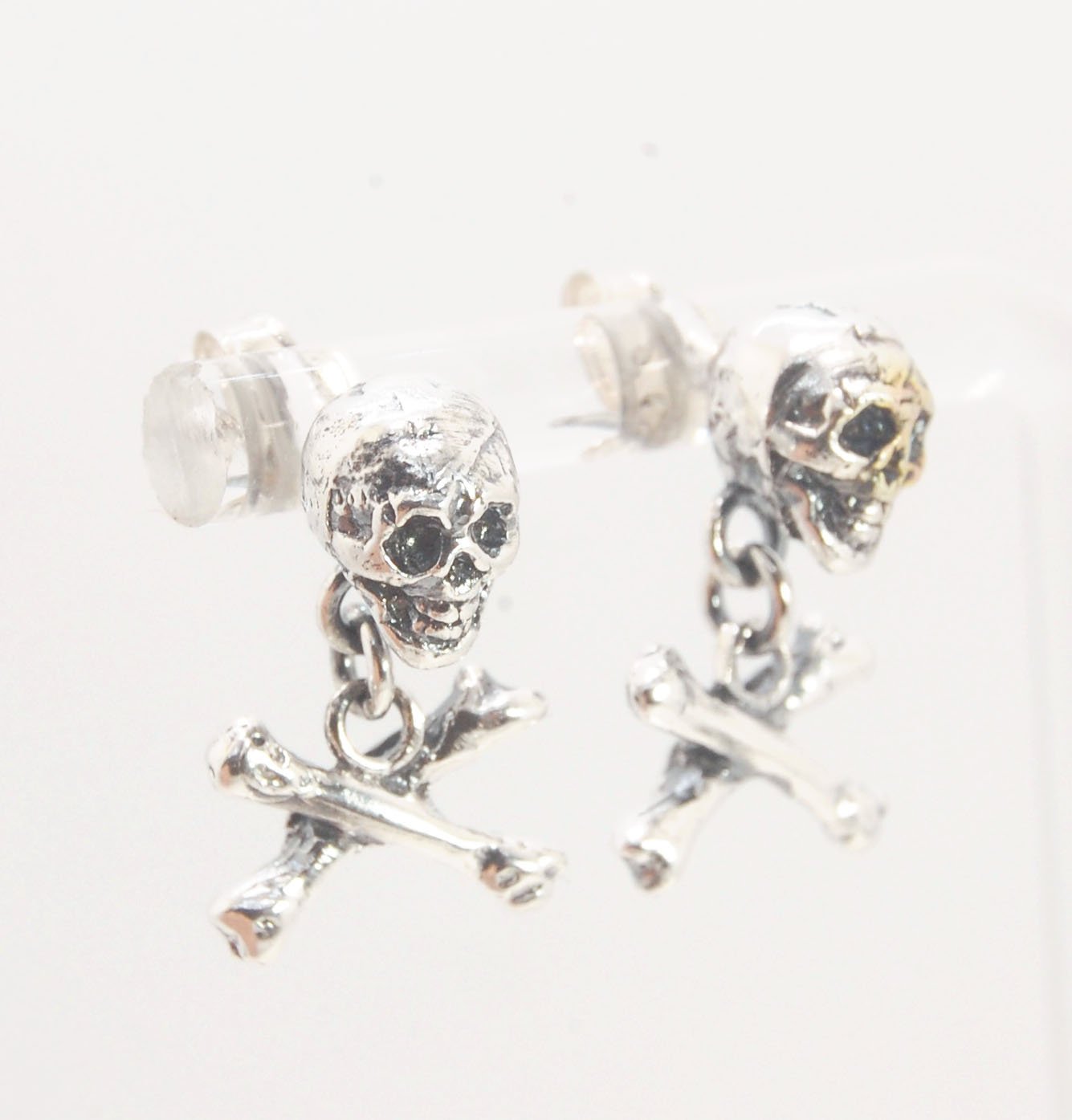 Skull & Bones Dangle Post Earrings These solid sterling silver Skull & Bones dangle earrings are wax carved by hand and cast using the ancient process of Lost Wax to cast them in sterling silver. I then made a mold, which I can inject with wax and make wa