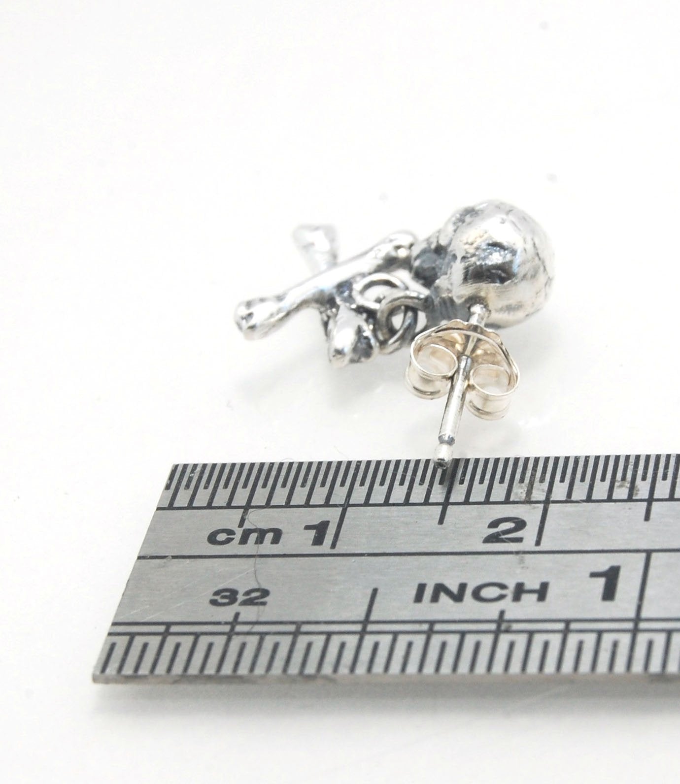 Skull & Bones Dangle Post Earrings These solid sterling silver Skull & Bones dangle earrings are wax carved by hand and cast using the ancient process of Lost Wax to cast them in sterling silver. I then made a mold, which I can inject with wax and make wa