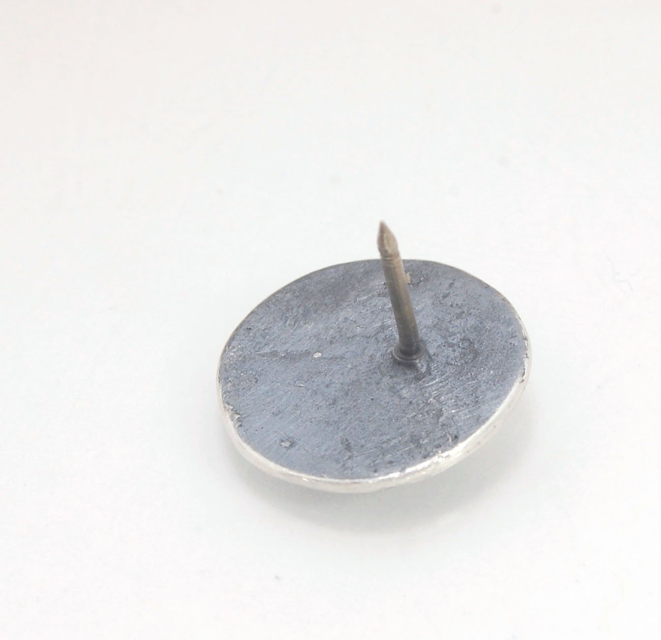 Skullbones Coin Lapel Pin These solid sterling silver SkullBones Coin Lapel Pin can also be worn as a Tie Tack. This Skullbones Coin is wax carved by hand and cast using the ancient process of Lost Wax to cast them in sterling silver. I then made a mold,