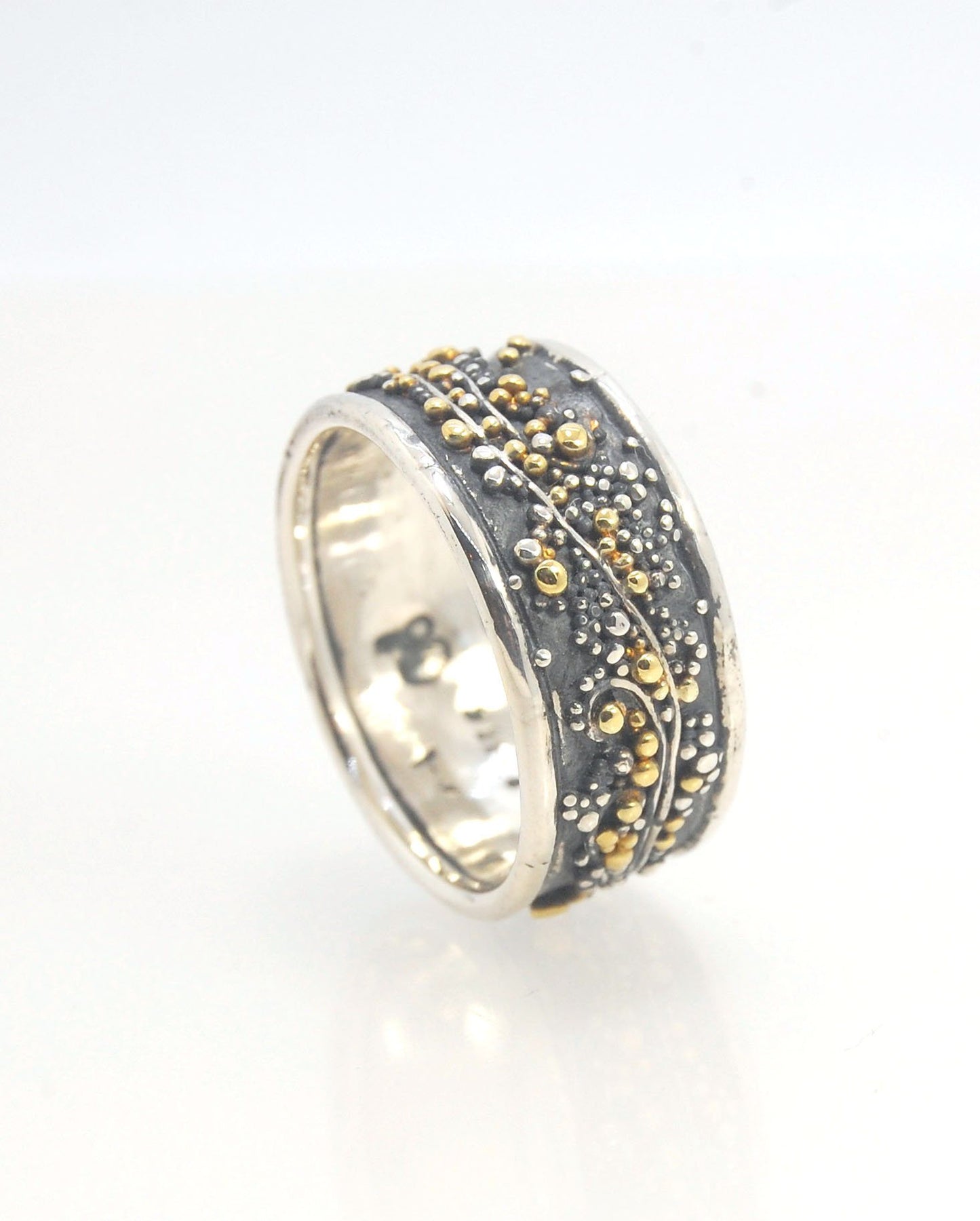 Cosmic Waves 18k and Fine Silver Granulation Ring 11mm wide This is very similar to the ring I made during the segment of “A Craftsman’s Legacy” on PBS a few years ago but with 18k gold granules of varying sizes. I am happy to make one for you in your siz