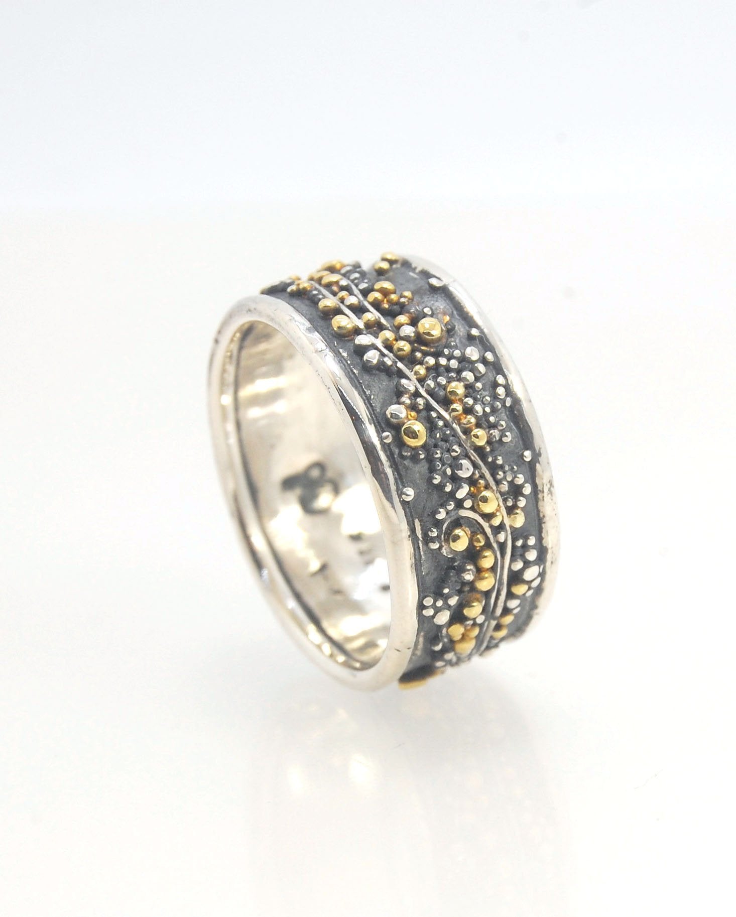 Cosmic Waves 18k and Fine Silver Granulation Ring 11mm wide This is very similar to the ring I made during the segment of “A Craftsman’s Legacy” on PBS a few years ago but with 18k gold granules of varying sizes. I am happy to make one for you in your siz