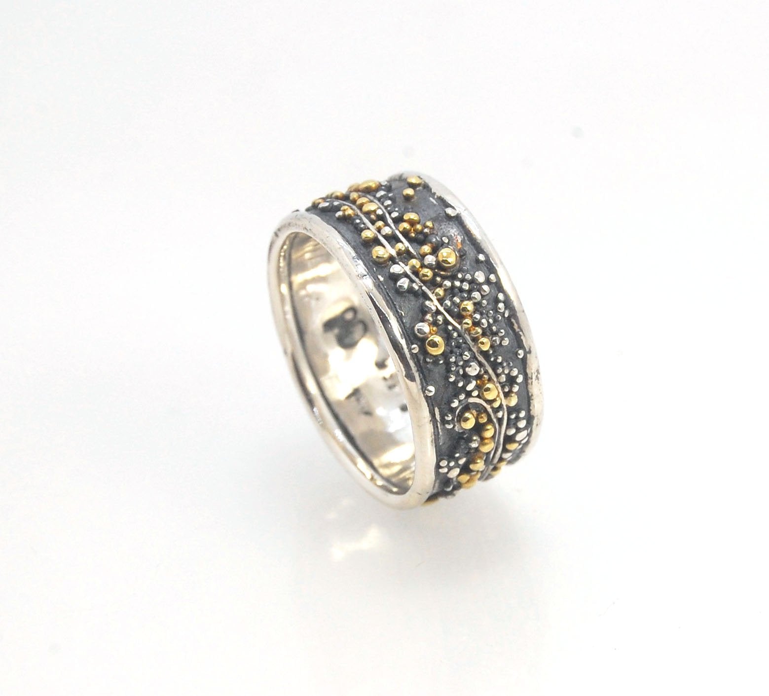 Cosmic Waves 18k and Fine Silver Granulation Ring 11mm wide This is very similar to the ring I made during the segment of “A Craftsman’s Legacy” on PBS a few years ago but with 18k gold granules of varying sizes. I am happy to make one for you in your siz