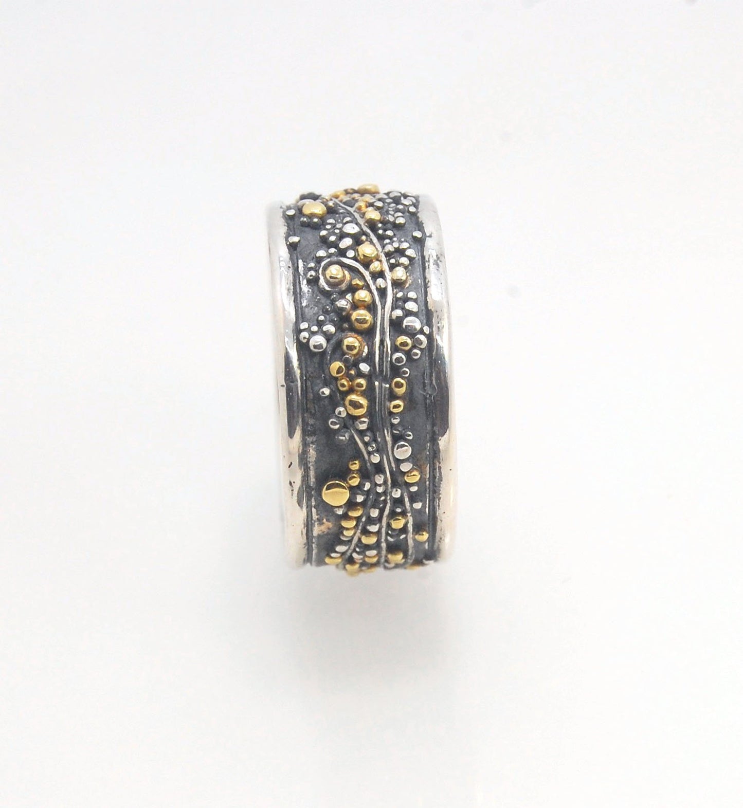 Cosmic Waves 18k and Fine Silver Granulation Ring 11mm wide This is very similar to the ring I made during the segment of “A Craftsman’s Legacy” on PBS a few years ago but with 18k gold granules of varying sizes. I am happy to make one for you in your siz