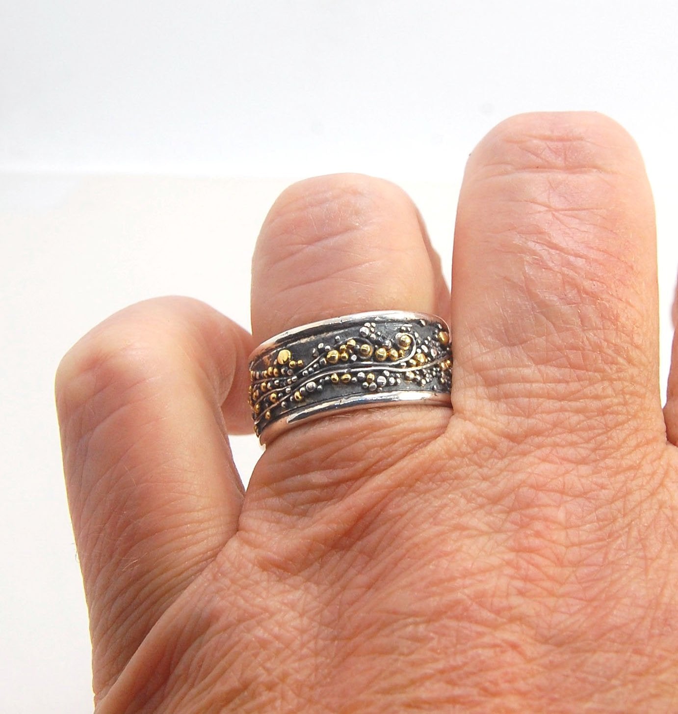 Cosmic Waves 18k and Fine Silver Granulation Ring 11mm wide This is very similar to the ring I made during the segment of “A Craftsman’s Legacy” on PBS a few years ago but with 18k gold granules of varying sizes. I am happy to make one for you in your siz