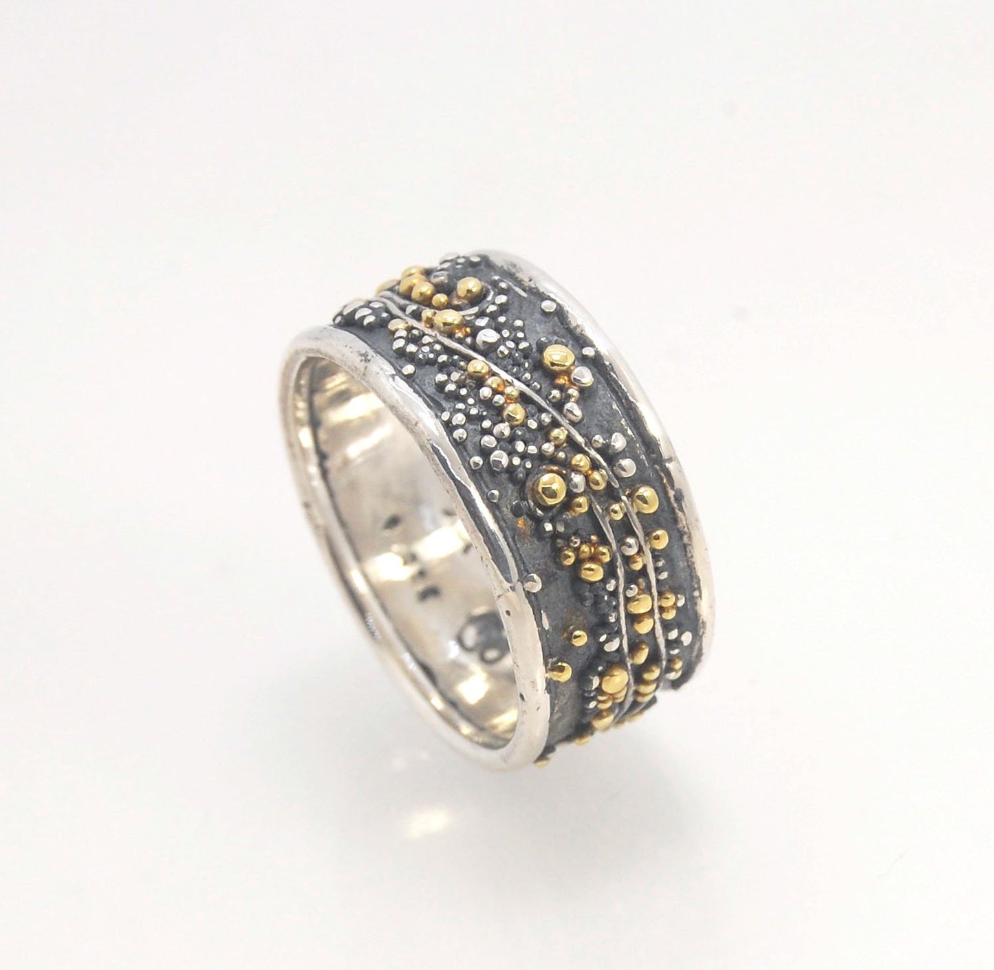 Cosmic Waves 18k and Fine Silver Granulation Ring 11mm wide This is very similar to the ring I made during the segment of “A Craftsman’s Legacy” on PBS a few years ago but with 18k gold granules of varying sizes. I am happy to make one for you in your siz