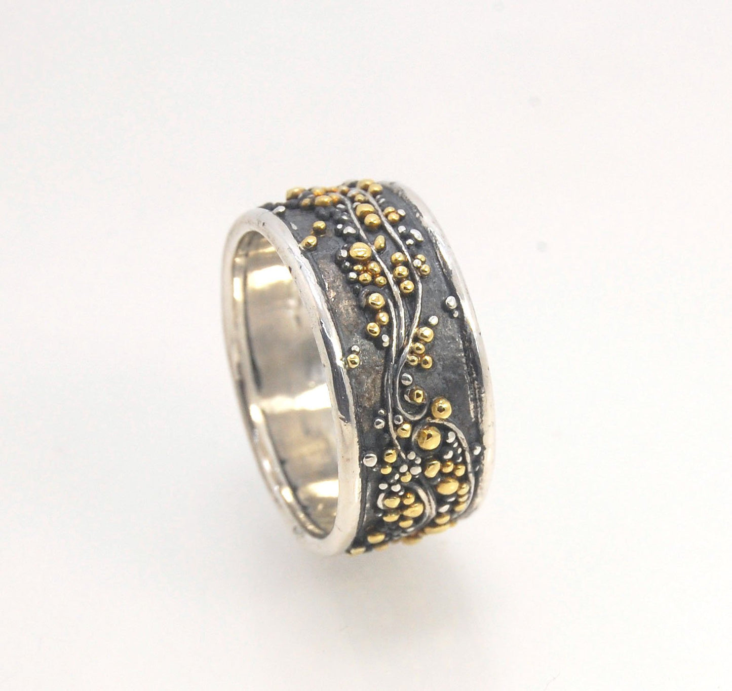 Cosmic Waves 18k and Fine Silver Granulation Ring 11mm wide This is very similar to the ring I made during the segment of “A Craftsman’s Legacy” on PBS a few years ago but with 18k gold granules of varying sizes. I am happy to make one for you in your siz
