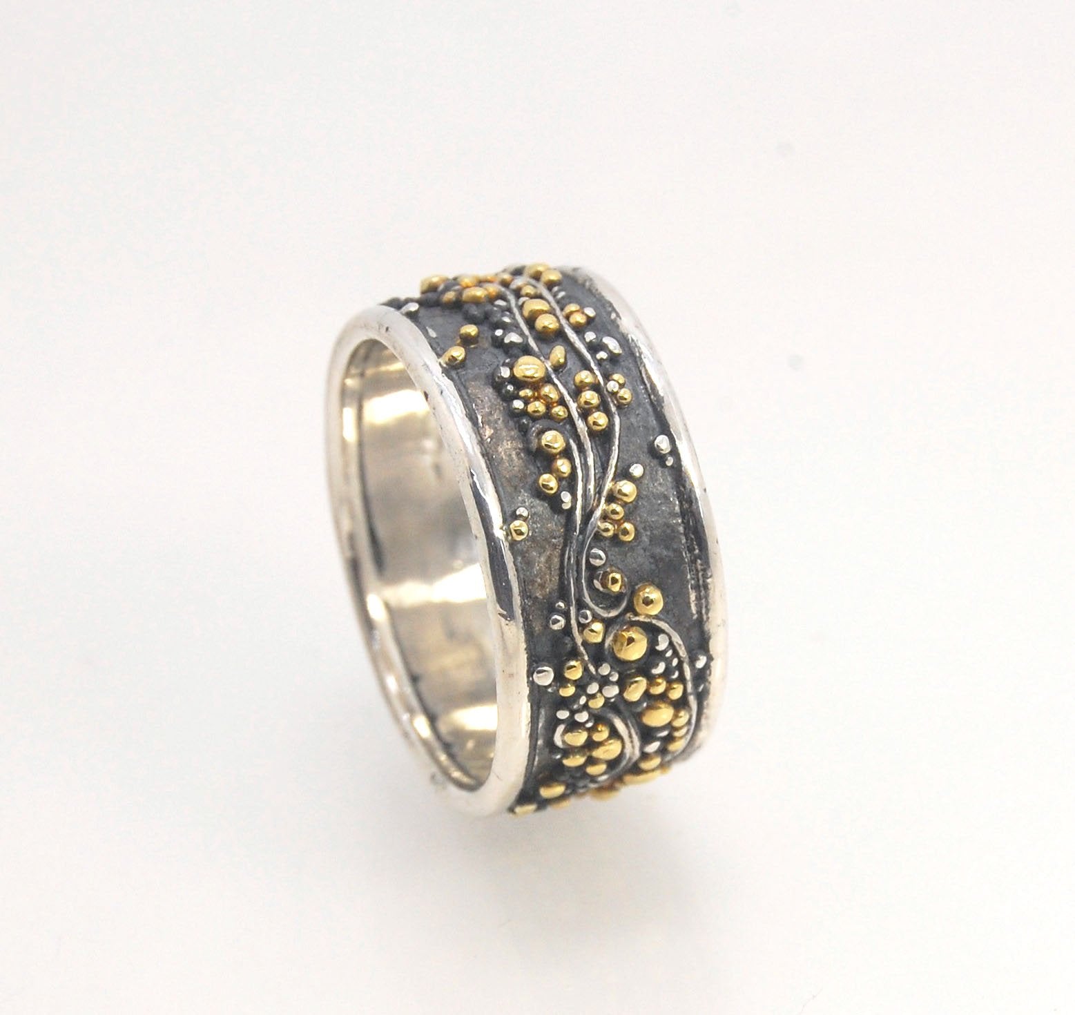 Cosmic Waves 18k and Fine Silver Granulation Ring 11mm wide This is very similar to the ring I made during the segment of “A Craftsman’s Legacy” on PBS a few years ago but with 18k gold granules of varying sizes. I am happy to make one for you in your siz