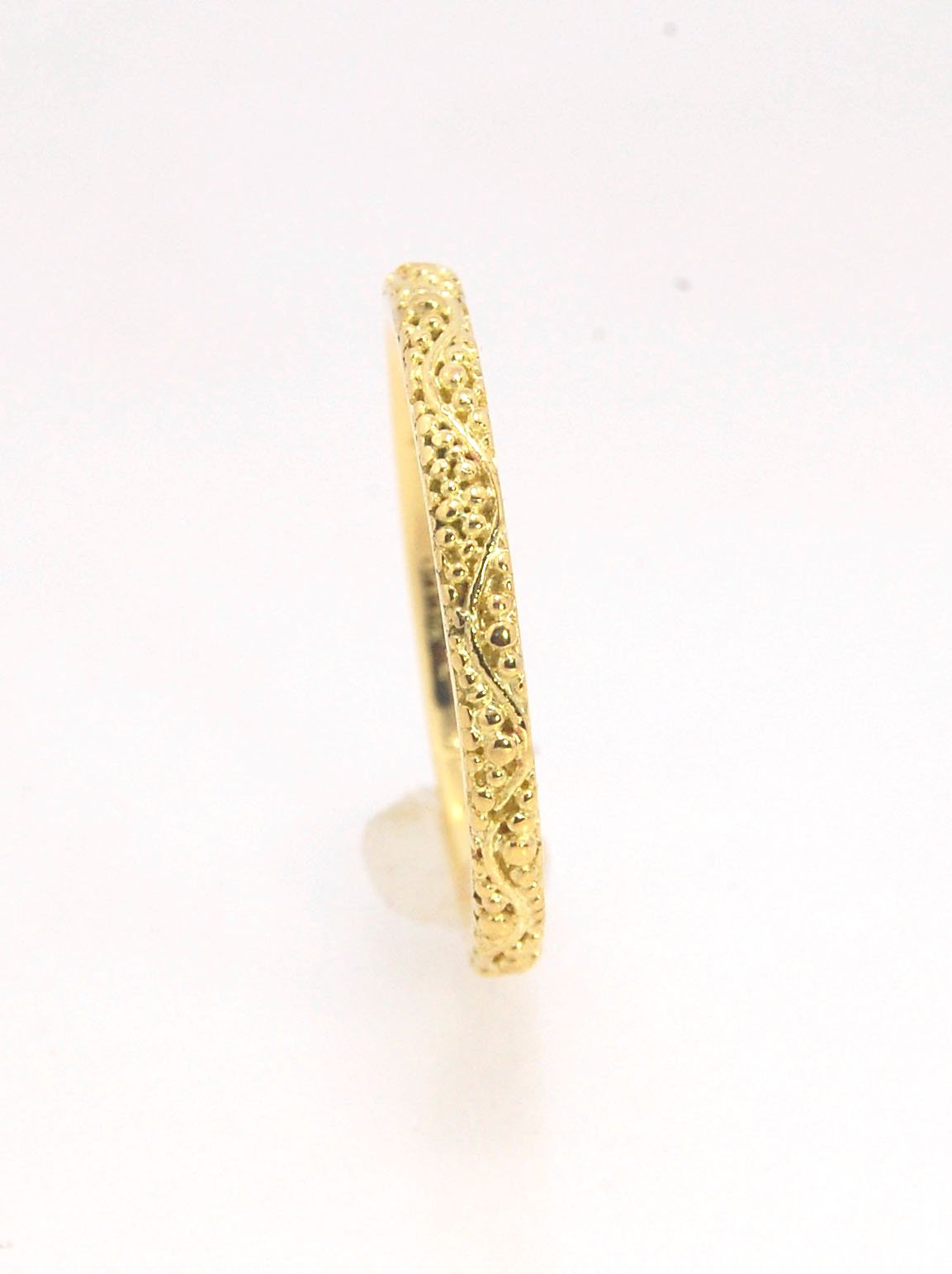 Twining Band in 18k Granulation This is a one-of-a-kind 18k ring handmade using the ancient process of granulation. The twining band is 2mm wide and has a continuous pattern around made with an ancient and unique process of granulation in 18k gold alloyed