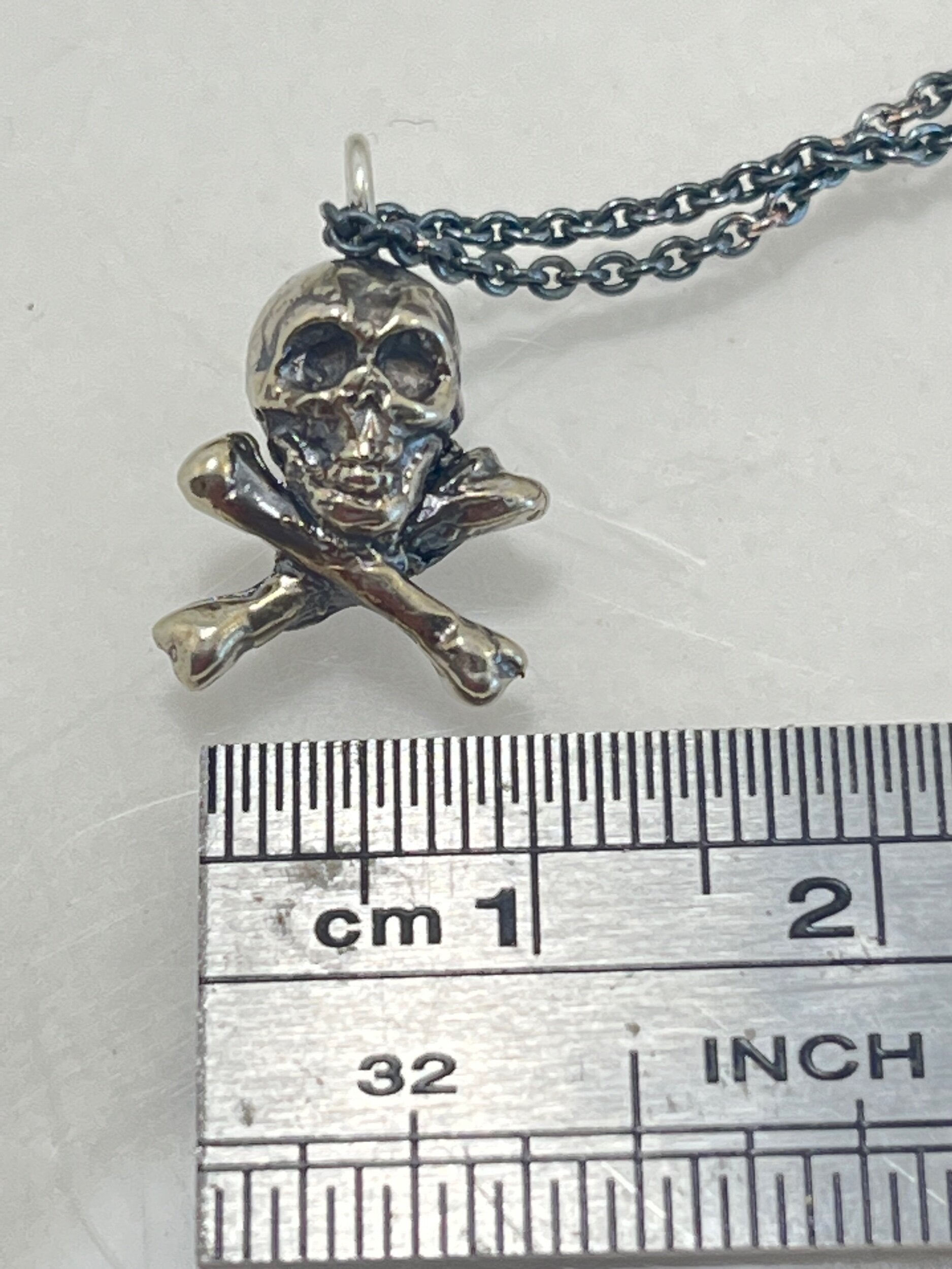 Jolly Roger Pendant This solid sterling silver Jolly Roger Pendant is wax carved by hand and cast using the ancient process of Lost Wax casting. I then made a mold, which I can inject with wax and make wax copies of the Jolly Roger Pendant and cast a lot