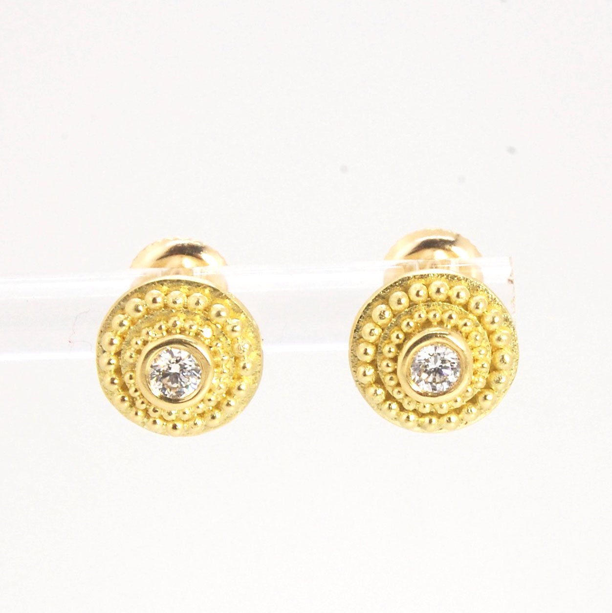 Diamond Disc Post Earrings - 18k Gold Granulation with 14k screw backs These Diamond Disc Stud Earrings are Classically-inspired 18k granulation. With 2 ethically-mined, .10ct , 3mm, Sl1, F+ round diamonds bezel-set in 18k a double ring of 18k gold granul