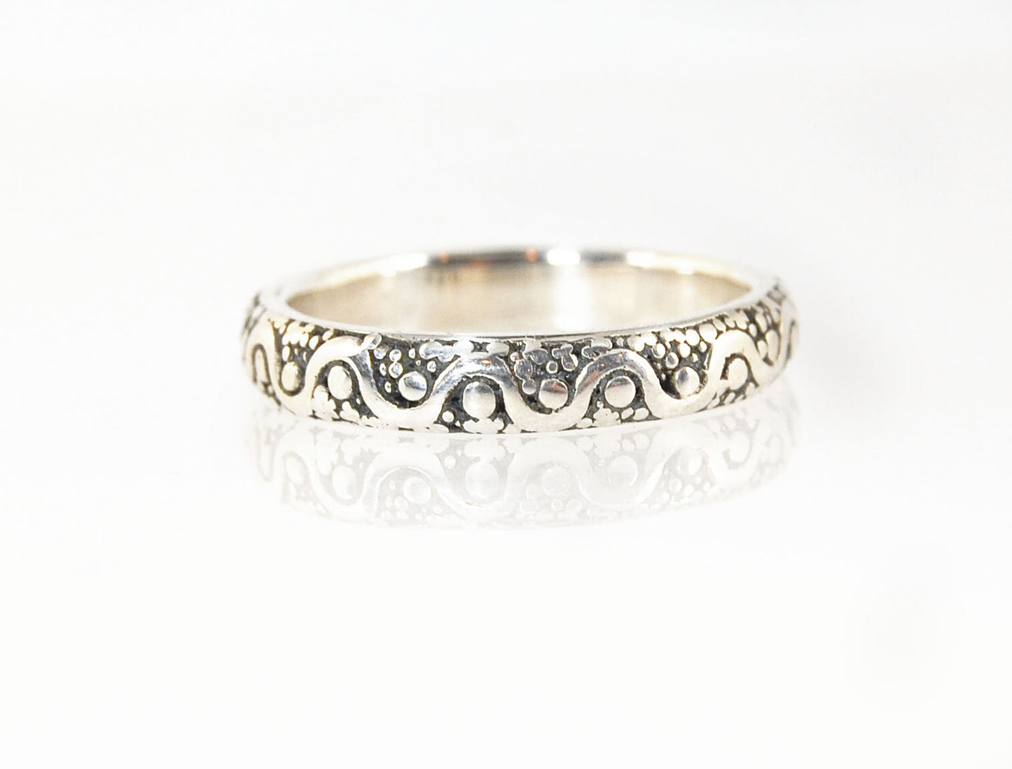 Squiggle and Dot Granulated Ring in Fine Silver or 18k Gold This lovely Squiggle and Dot design band is unique and made by hand using the ancient process of Granulation. Granulation is a controlled fusing process utilized for thousands of years which can