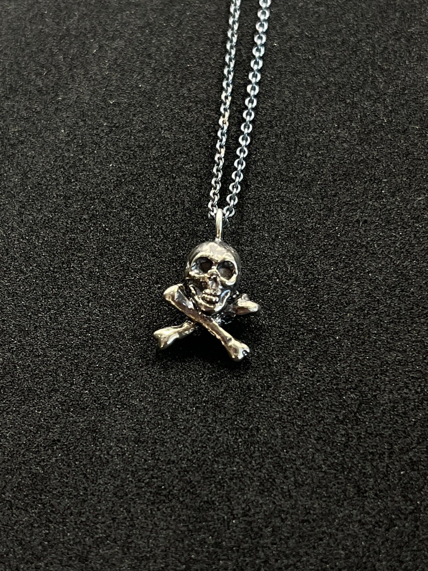 Jolly Roger Pendant This solid sterling silver Jolly Roger Pendant is wax carved by hand and cast using the ancient process of Lost Wax casting. I then made a mold, which I can inject with wax and make wax copies of the Jolly Roger Pendant and cast a lot