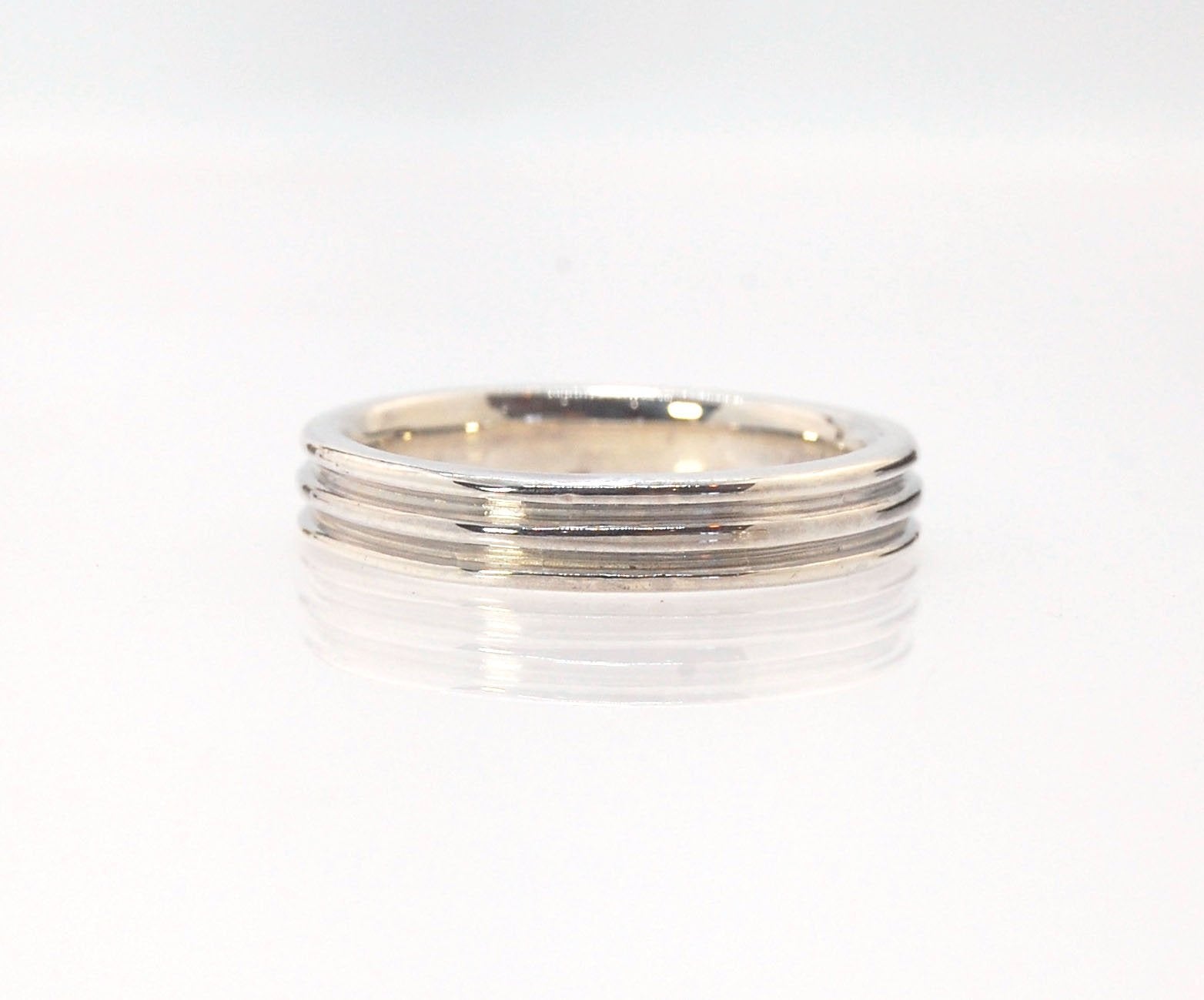 3 Rim 4.3 wide band - Sterling silver, 14k or 18k yellow gold This is a narrow 3 rim band cast from a wax carving turned on a lathe and then cast in the metal of your choice using the lost wax process. These are so much fun to make and I have several vari