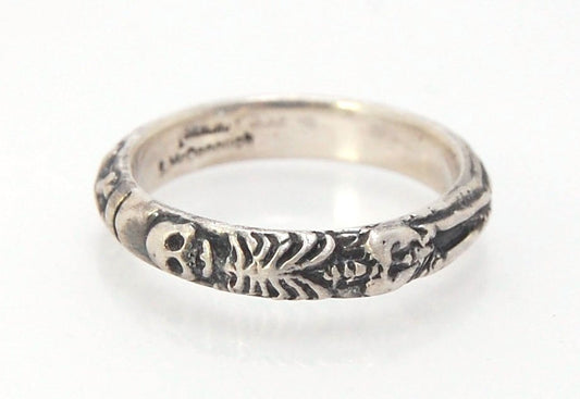 Oxidized Memento Mori Skeleton Ring - 4mm - Sterling Silver This is the middle width of my Memento Mori skeleton rings at 4mm wide. The Skeleton is flanked by crossed bones on one side and an hourglass on the other.Unlike my Enameled Memento Mori Rings, t